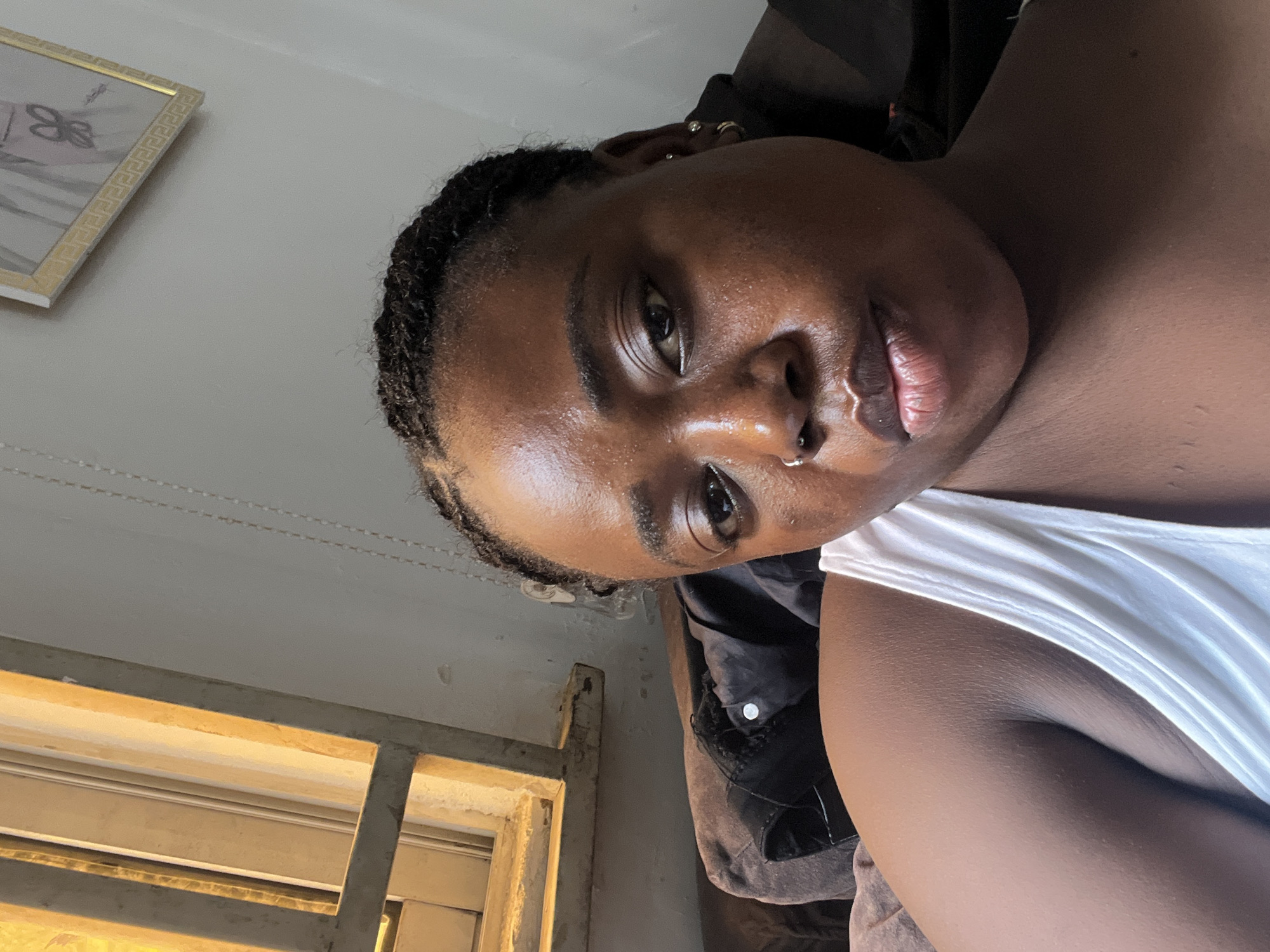 Relaxed afternoon at home in Abuja, phone in hand