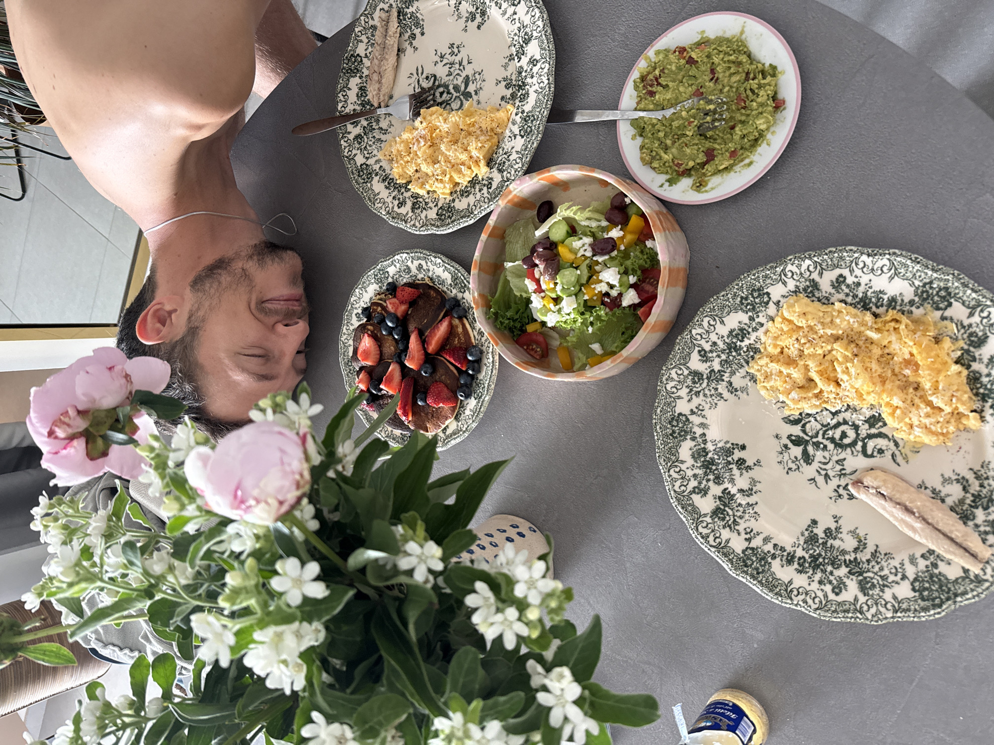 Breakfast scene captured with upside-down man in Tel Aviv