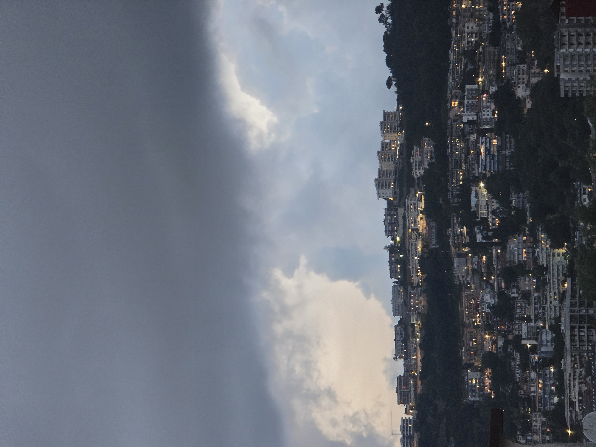 Evening scenes from Salerno: hillside cityscape and orange tabby cat