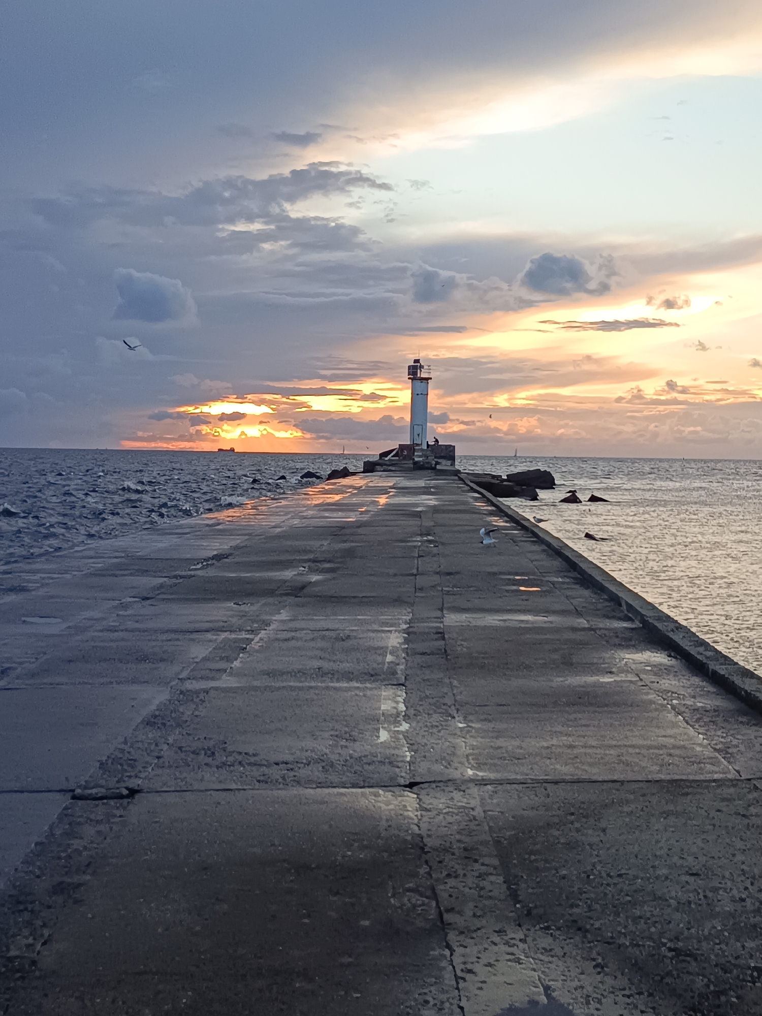 Stormy sunset at a Riga pier lighthouse