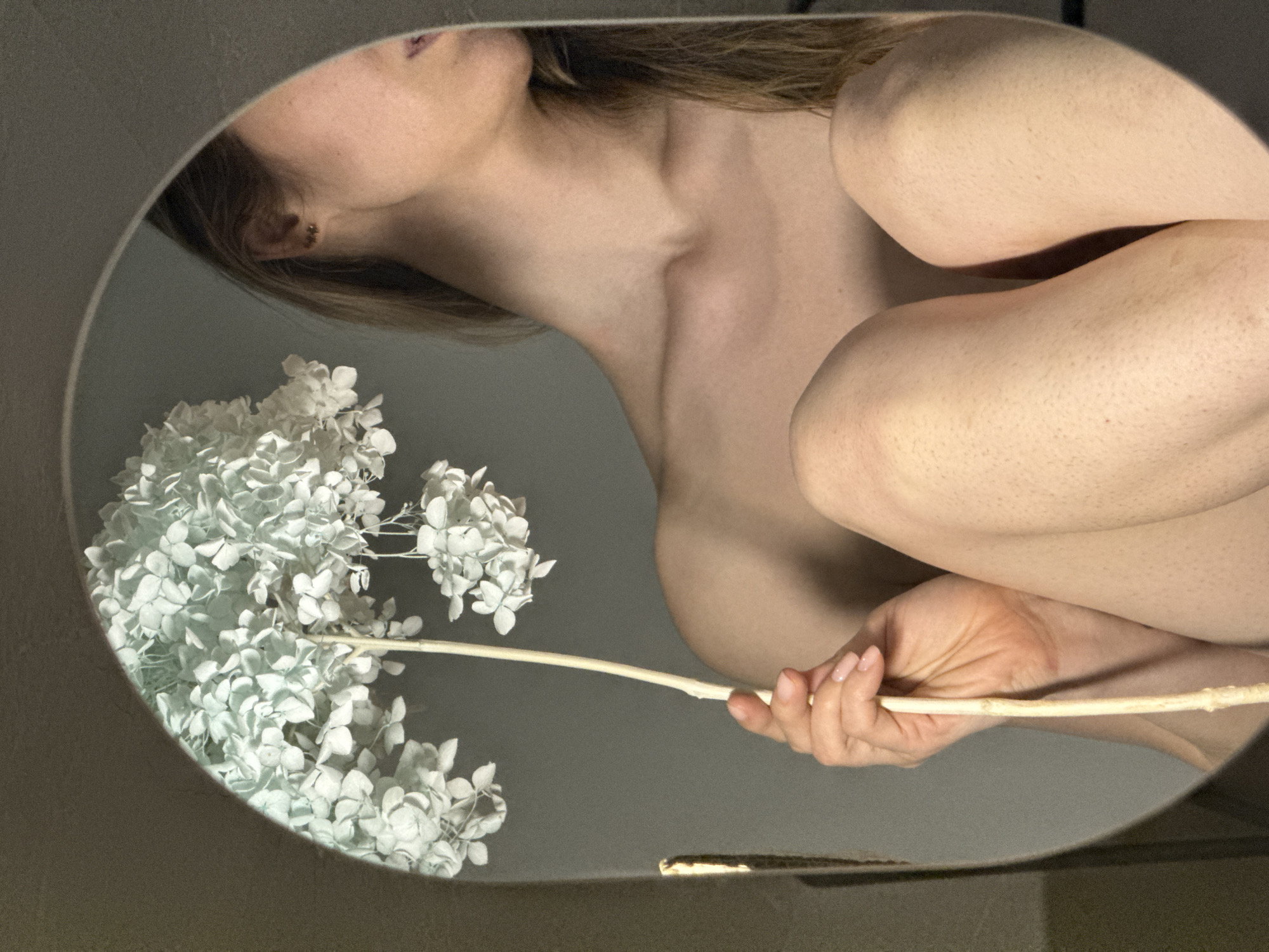Woman takes floral mirror selfies in Chaikovsky, Russia
