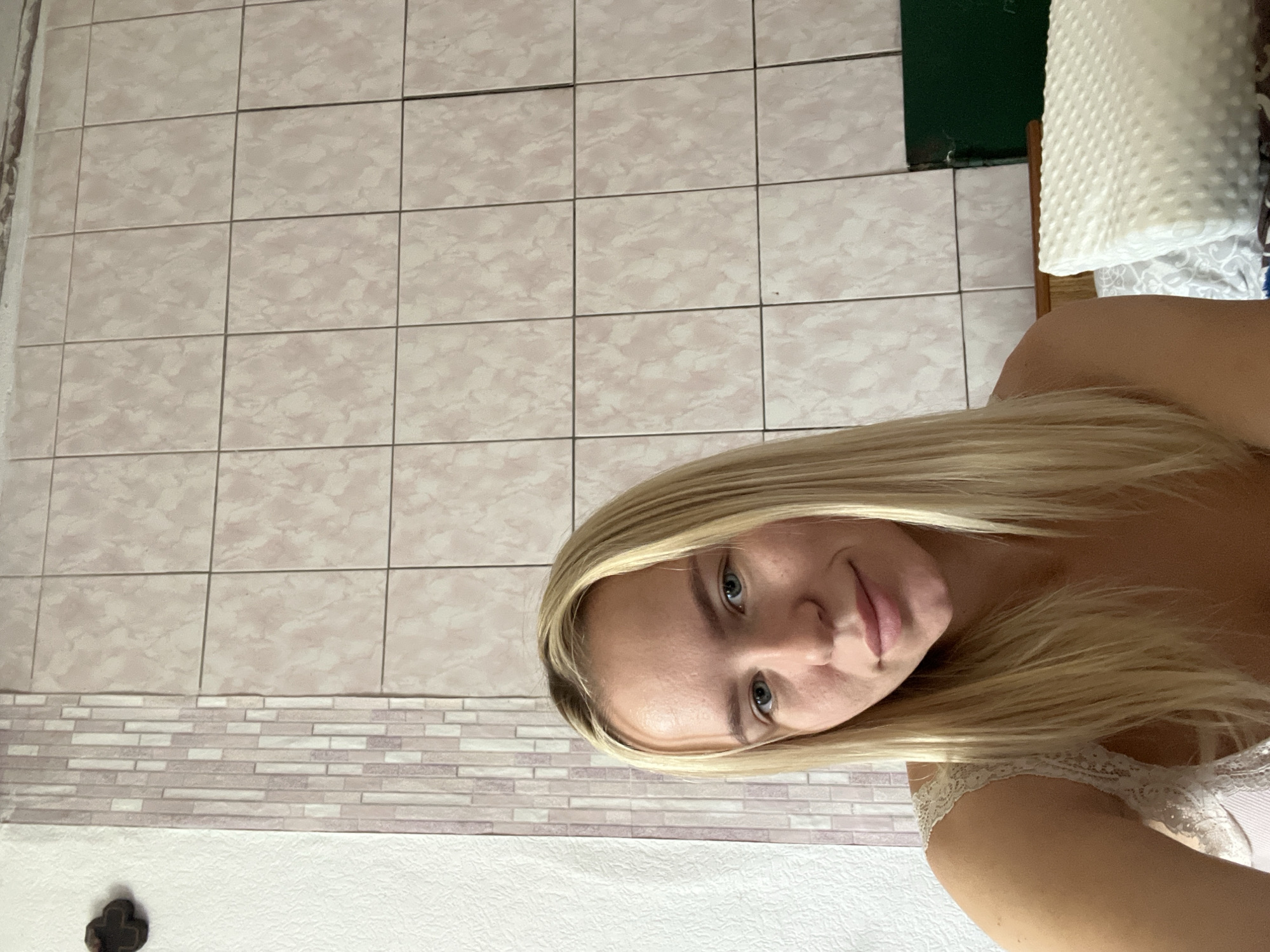 Indoor selfie session surrounded by patterned walls and couple paintings