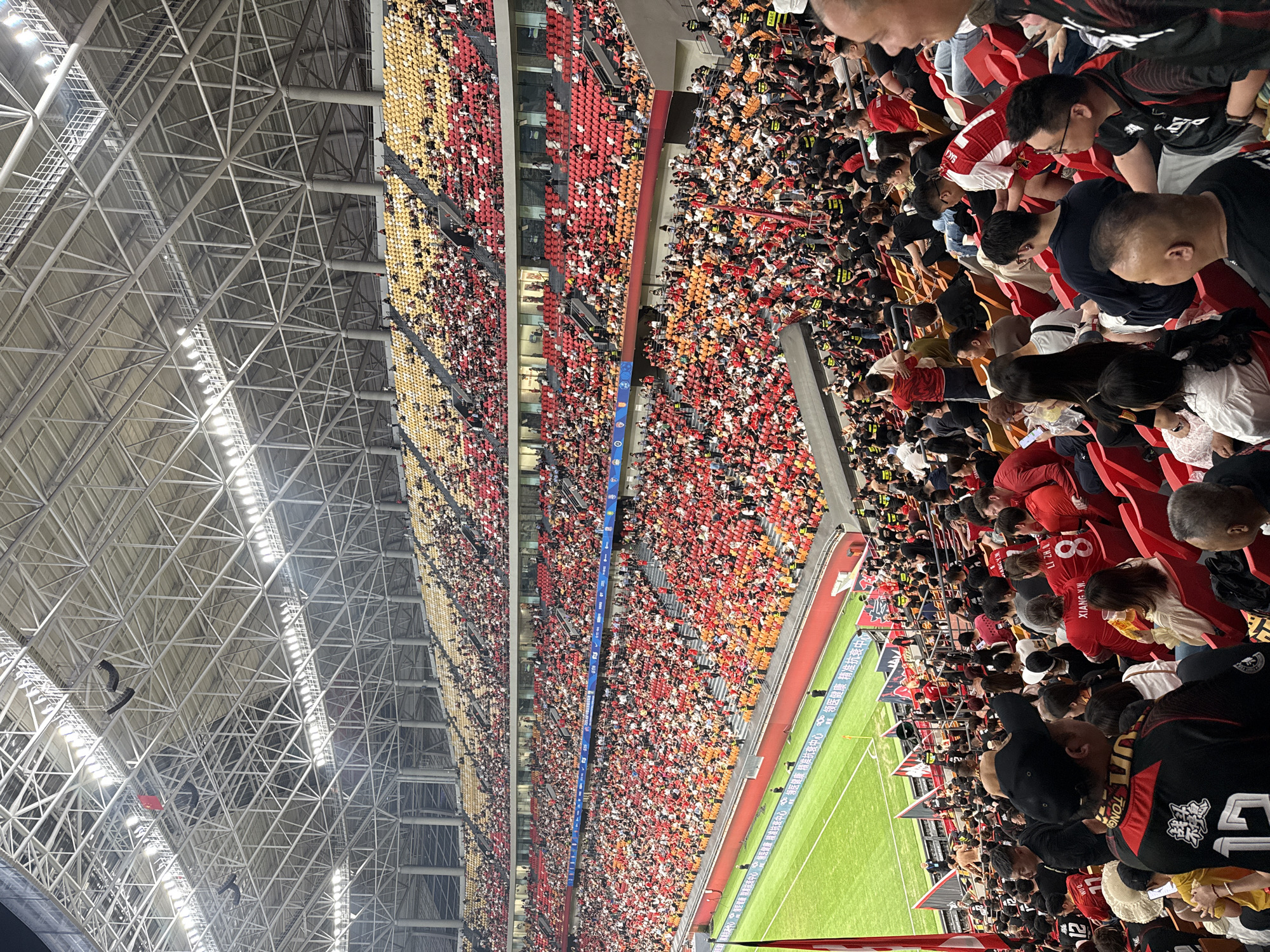 Stadium packed with red-black wearing fans in Longxing