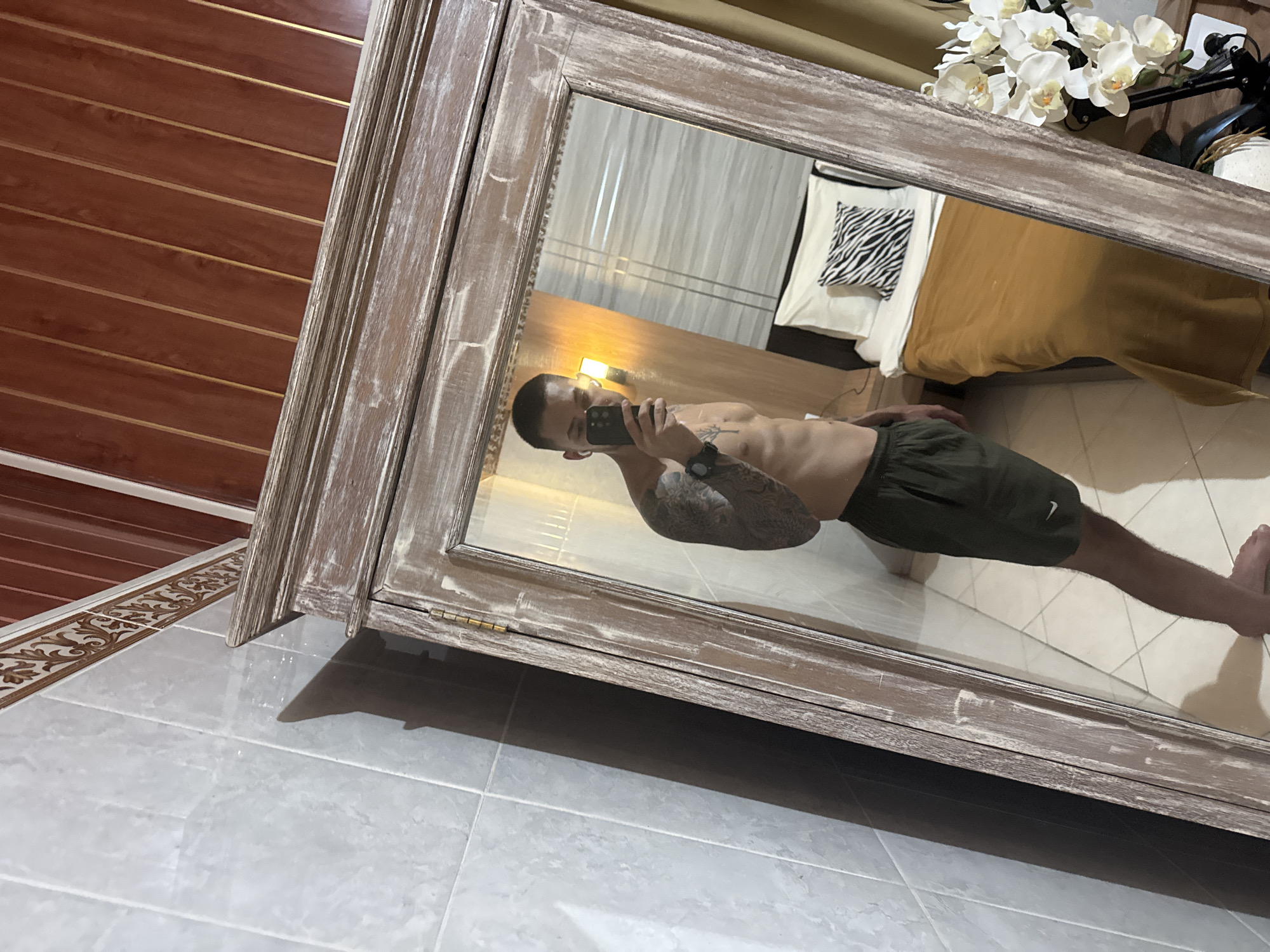 Man Takes Morning Selfie in Bedroom Mirror in Munggu