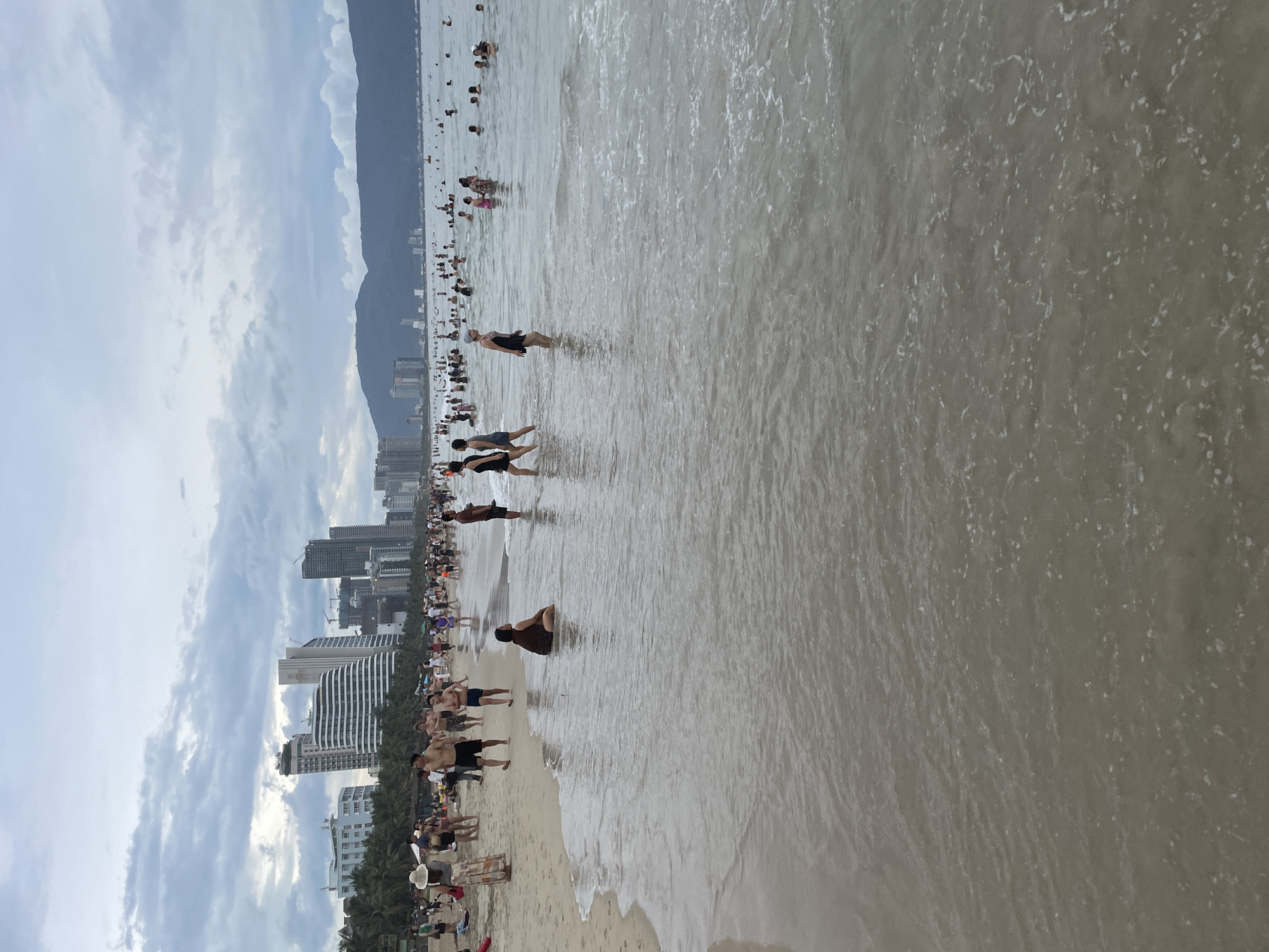 Crowded day at My Khe Beach, Đà Nẵng, under grey skies