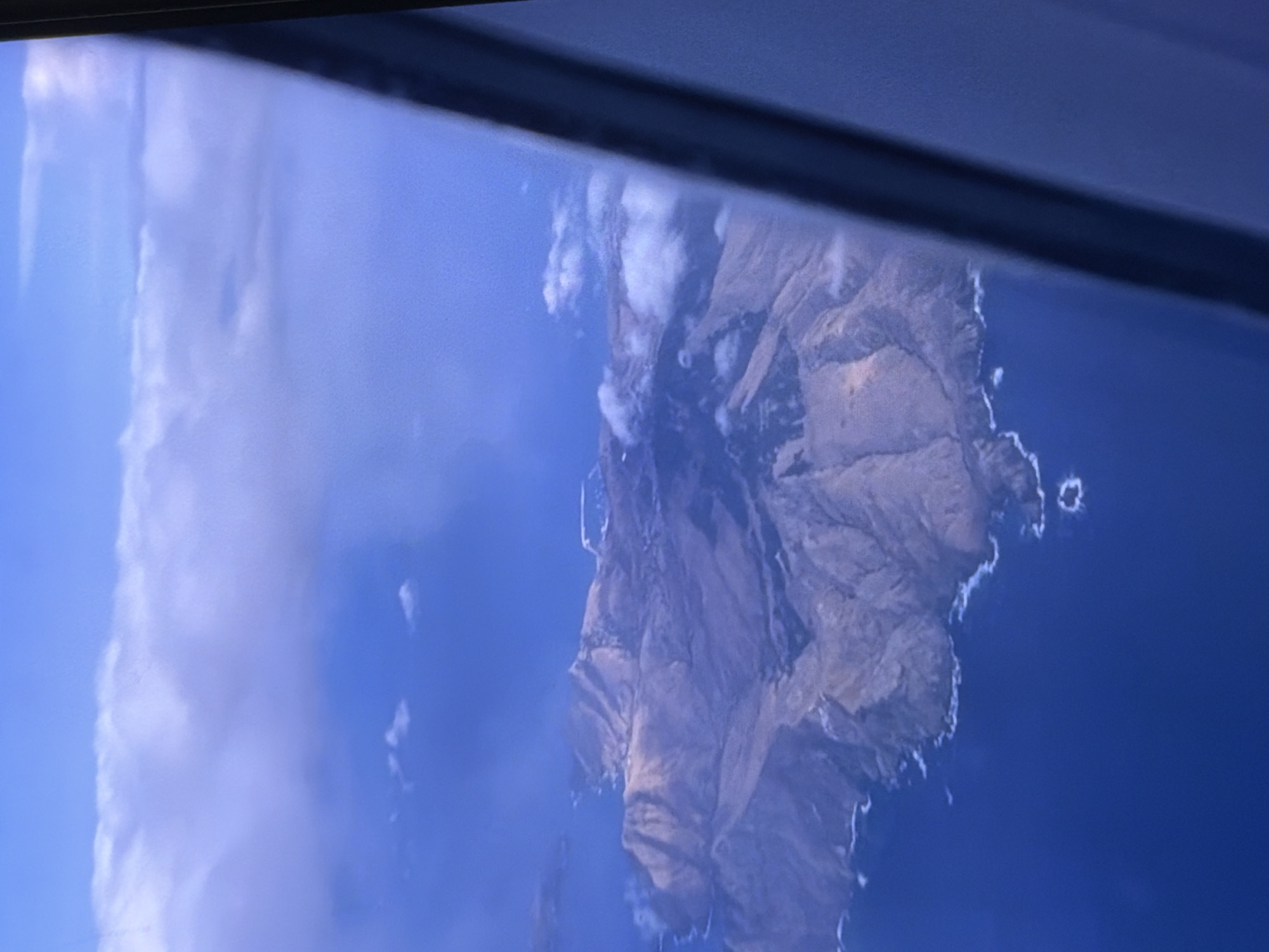Flight over volcanic islands, tarmac stops at a sunny island airport