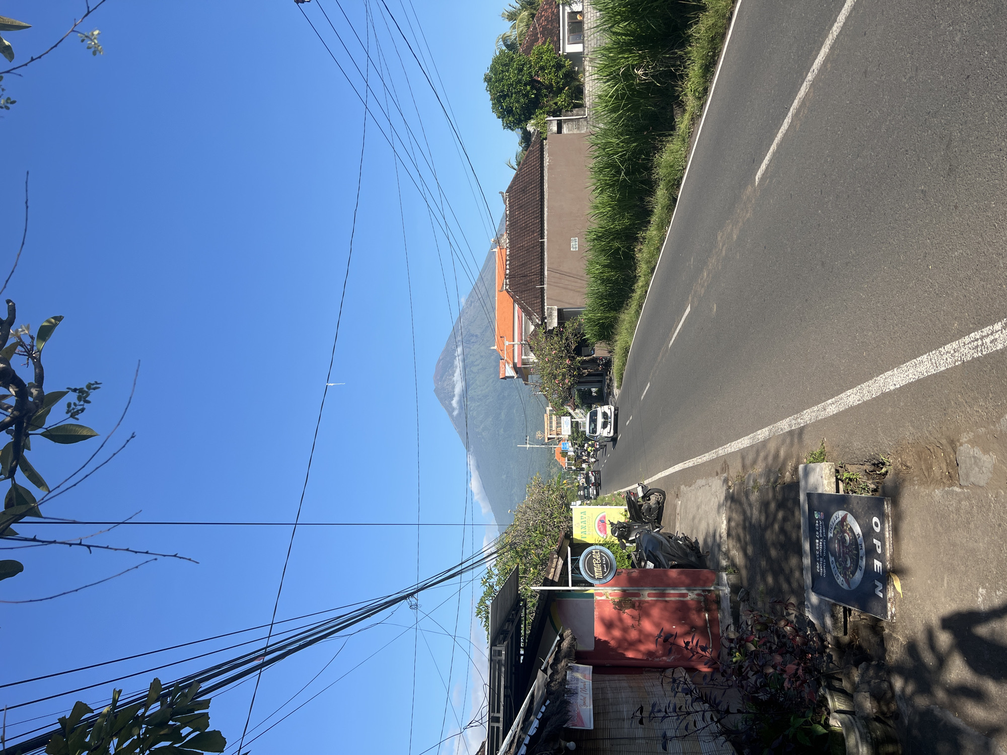 Street scene captured with volcano backdrop in Abang, Indonesia