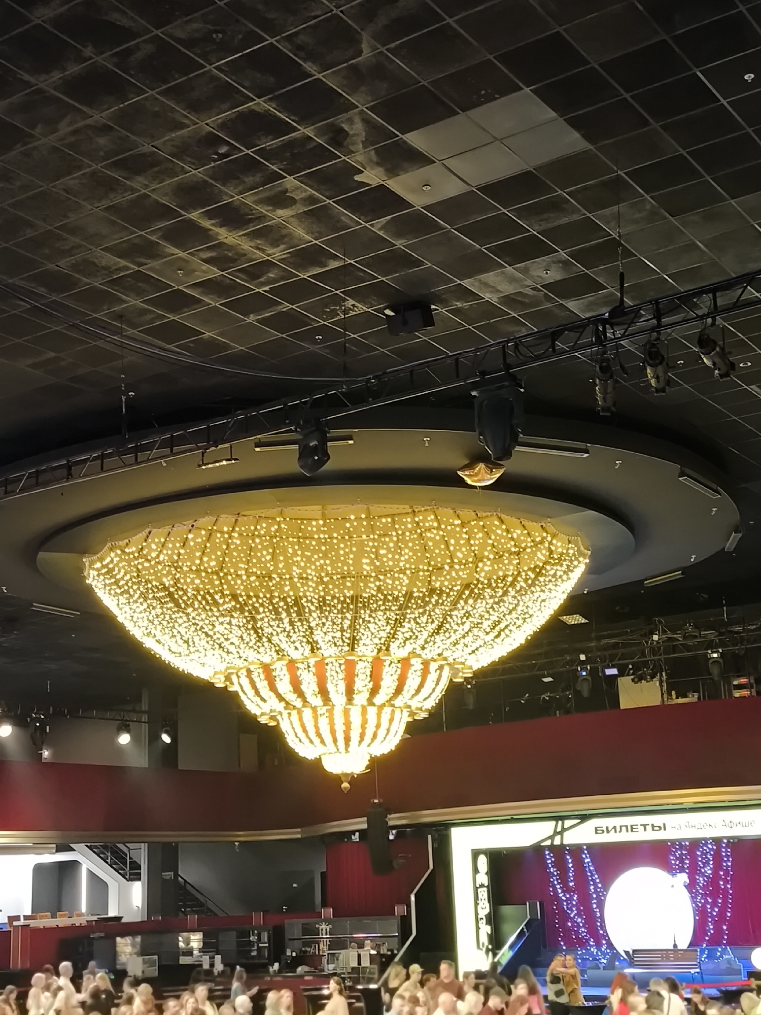Theater performance with ornate staging draws audience phone flashlights