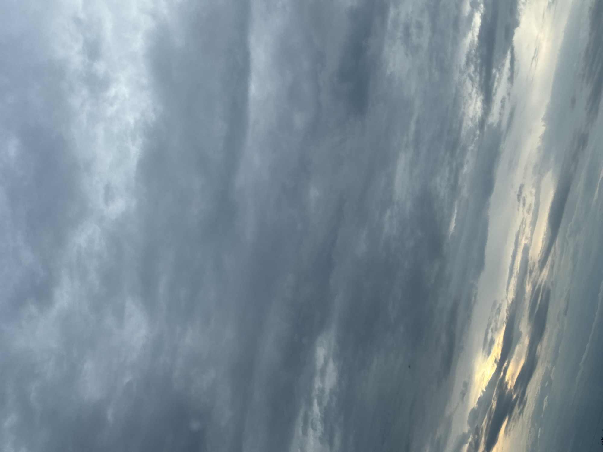 Gray overcast sky with faint light breaking through the clouds