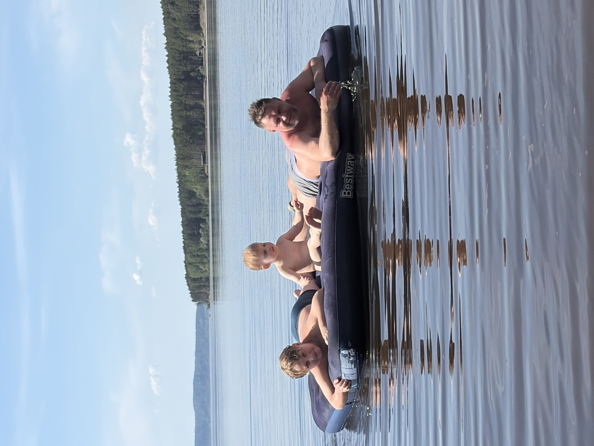 Family group rafting on lake near Vekoshinka, Russia