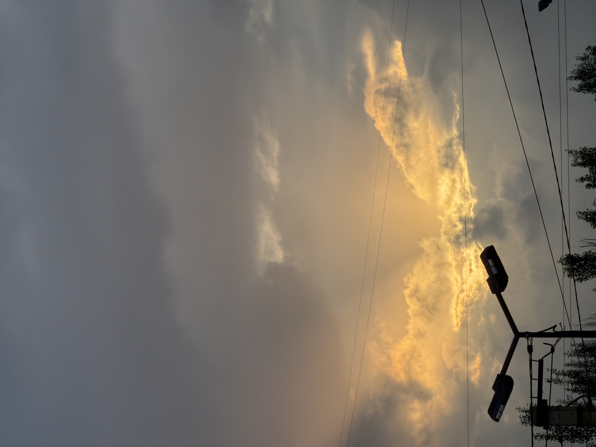 Dramatic golden light breaks through storm clouds over Bishkek