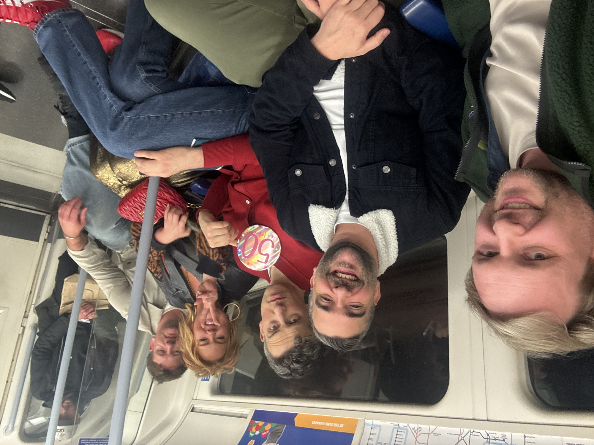 Seven people travel together on London Underground train