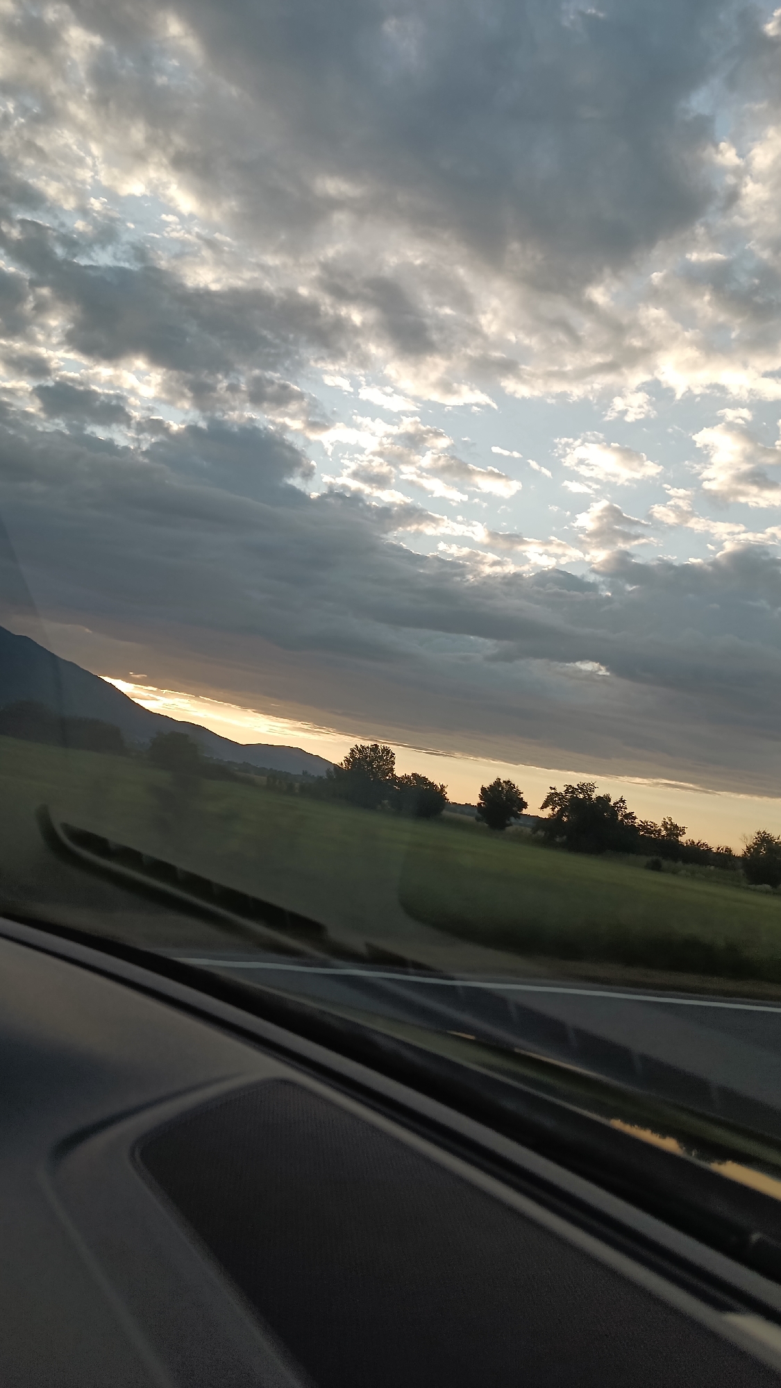 Cloudy sunset through a windshield near Maglizh, Bulgaria
