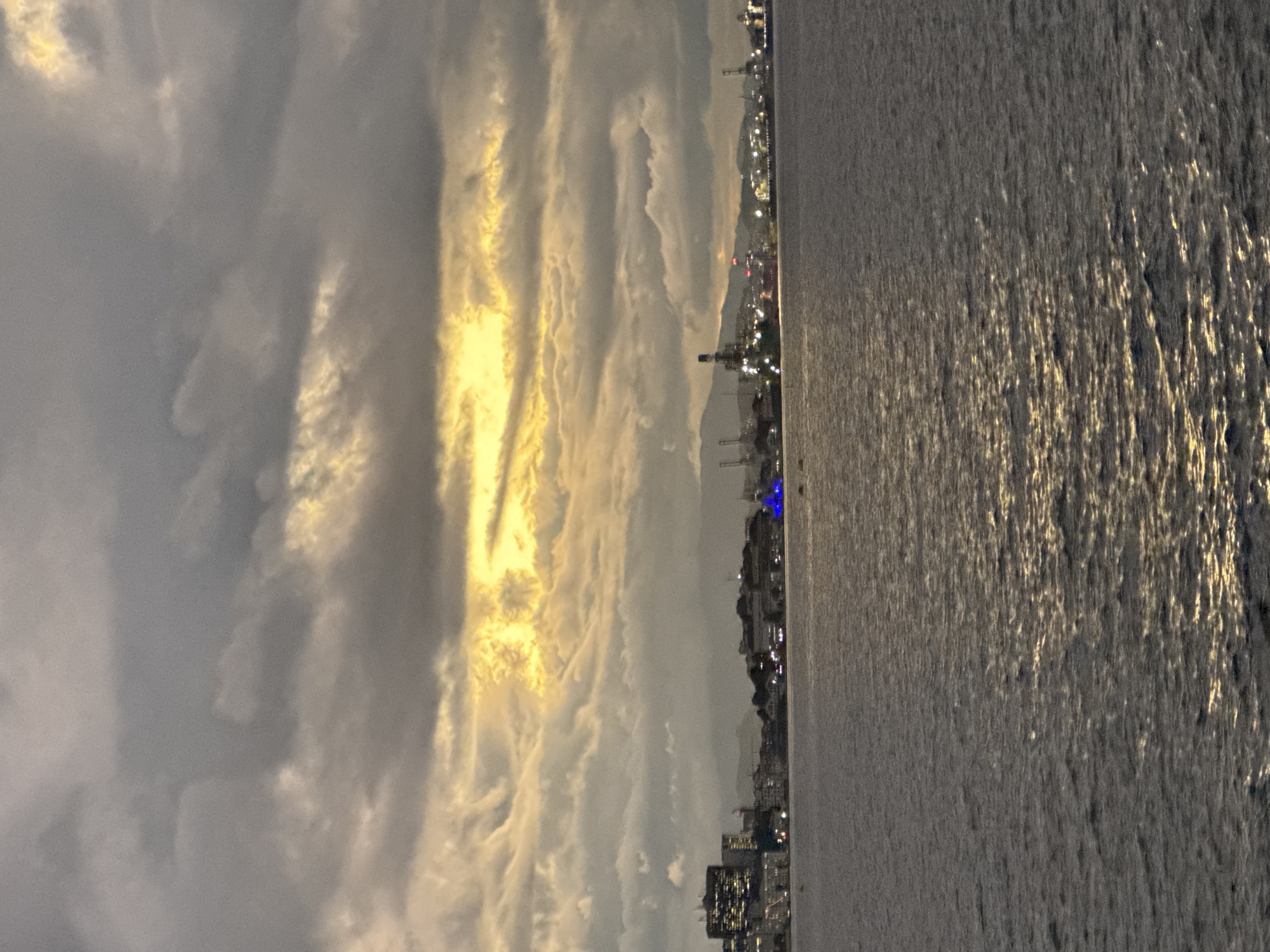 Niterói skyline at dusk, calm water and breaking light