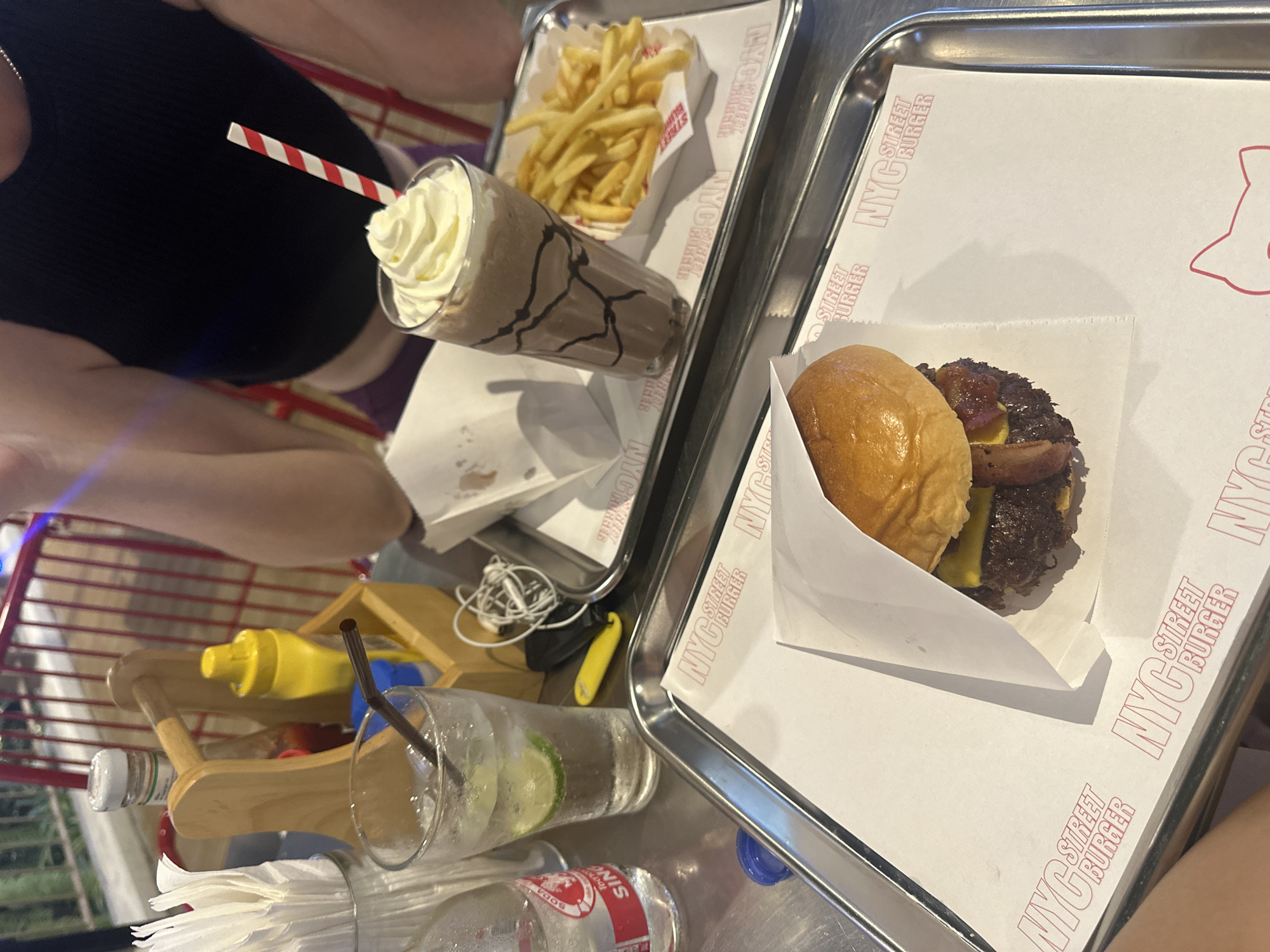 Woman enjoys burger meal at NYC Street Burger Thailand