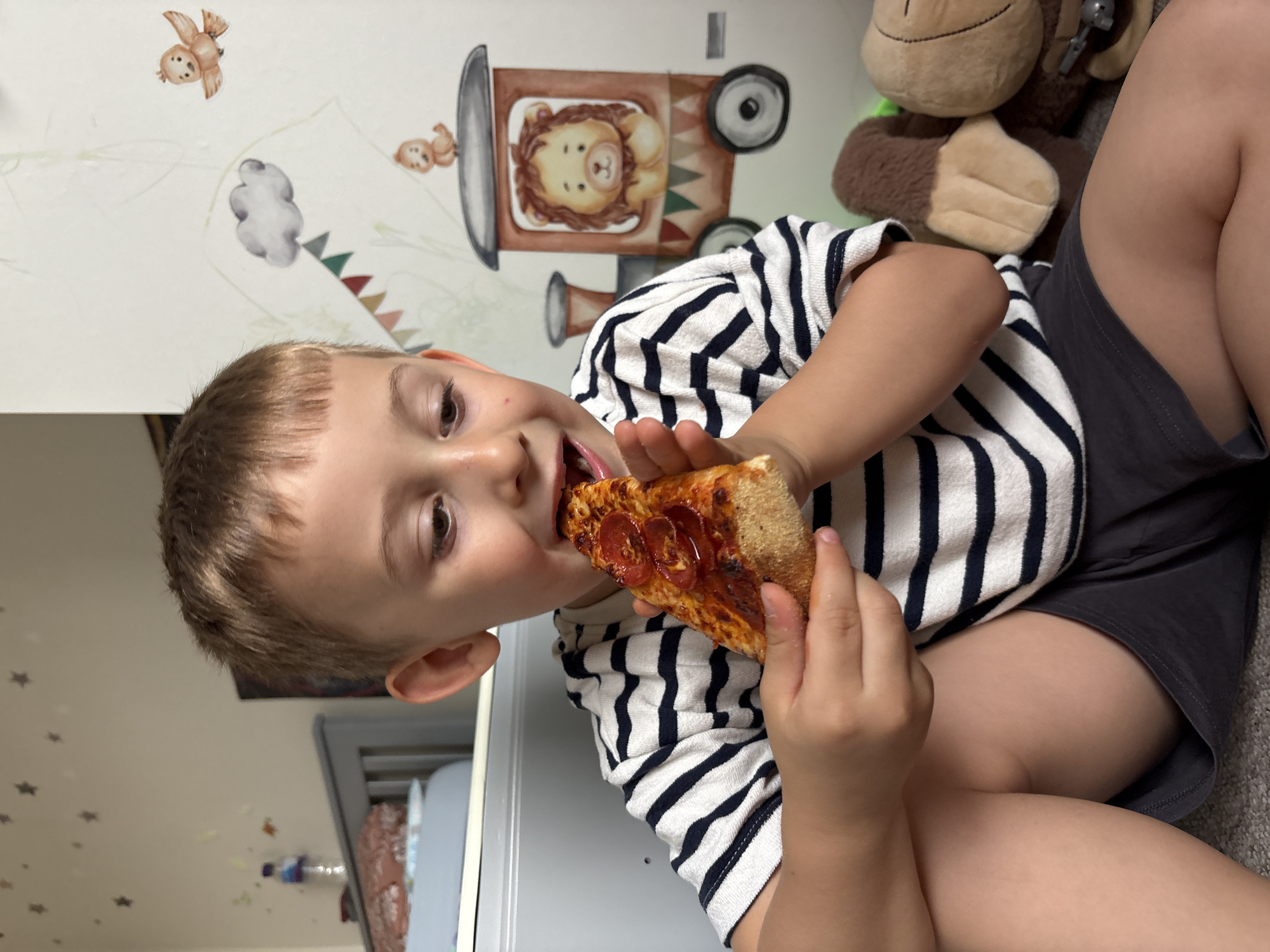 Boy enjoys pizza meal in London home