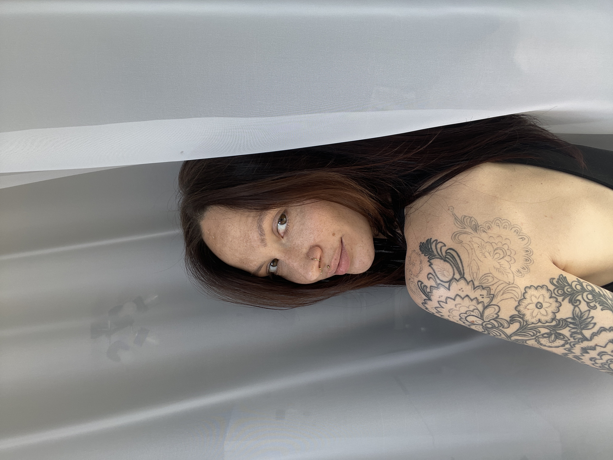 Woman with tattoos, piercings observed resting in Yakshur, Russia