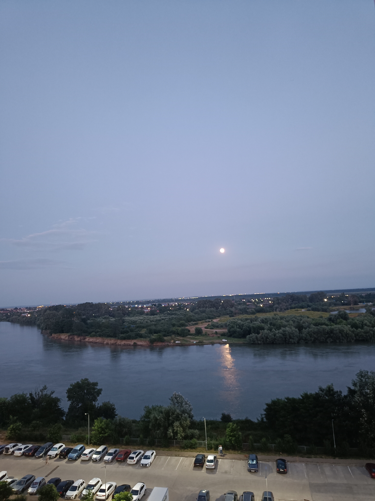 Kuban River and Krasnodar skyline at dusk, full moon rising