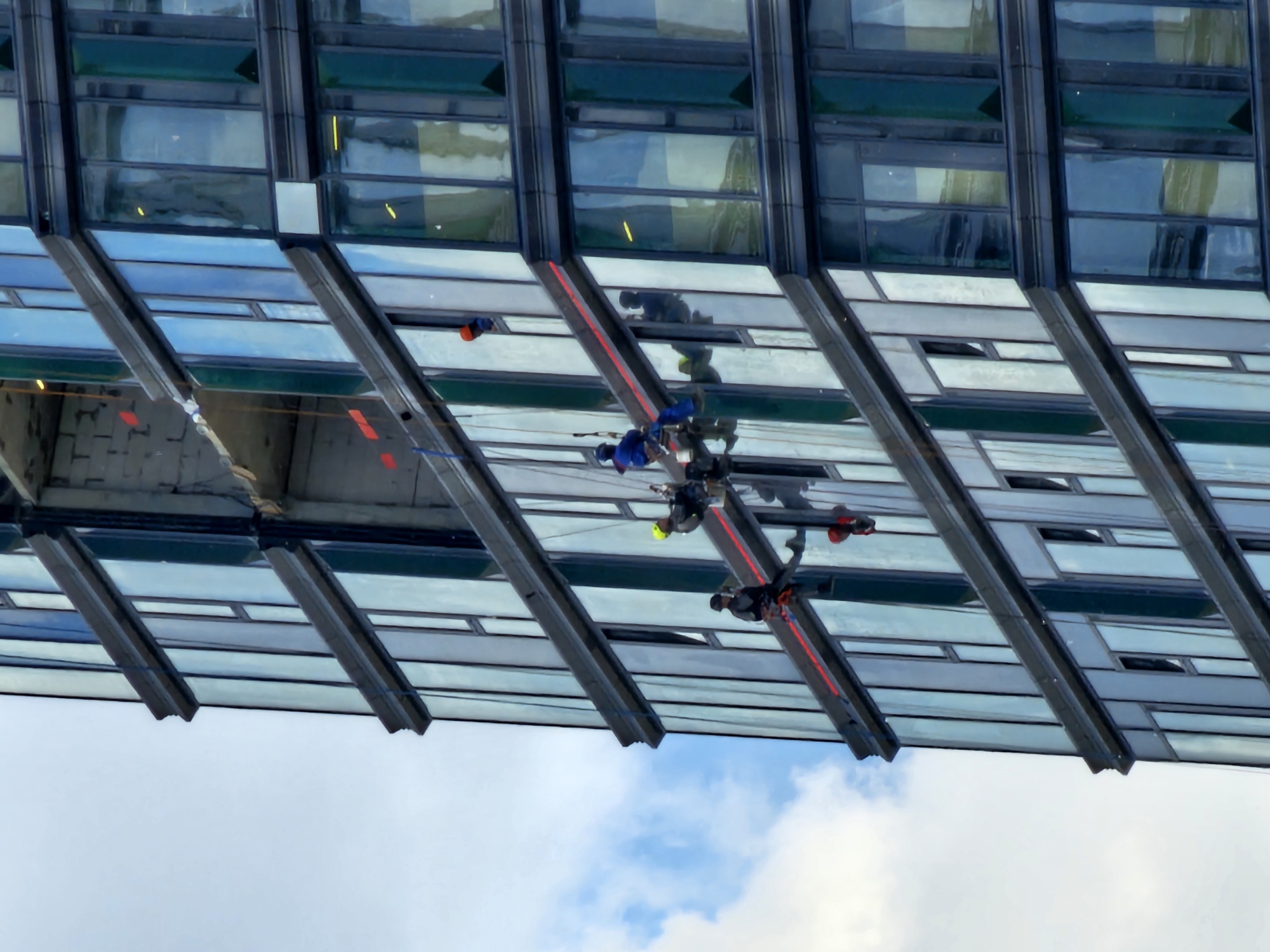 Window washers work on Moscow skyscraper exterior maintenance operations