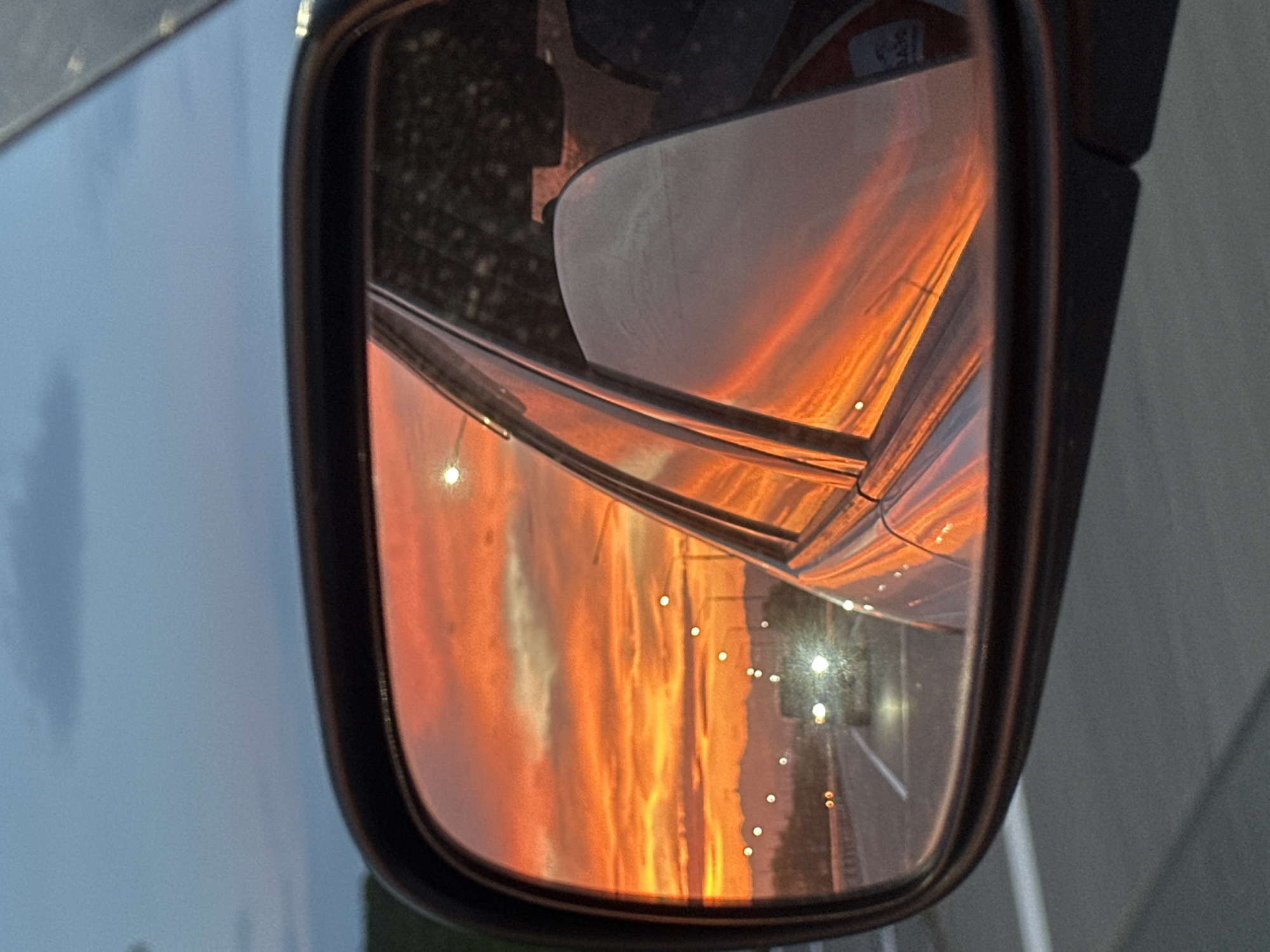 Yelizovo highway sunset caught in a car's side mirror