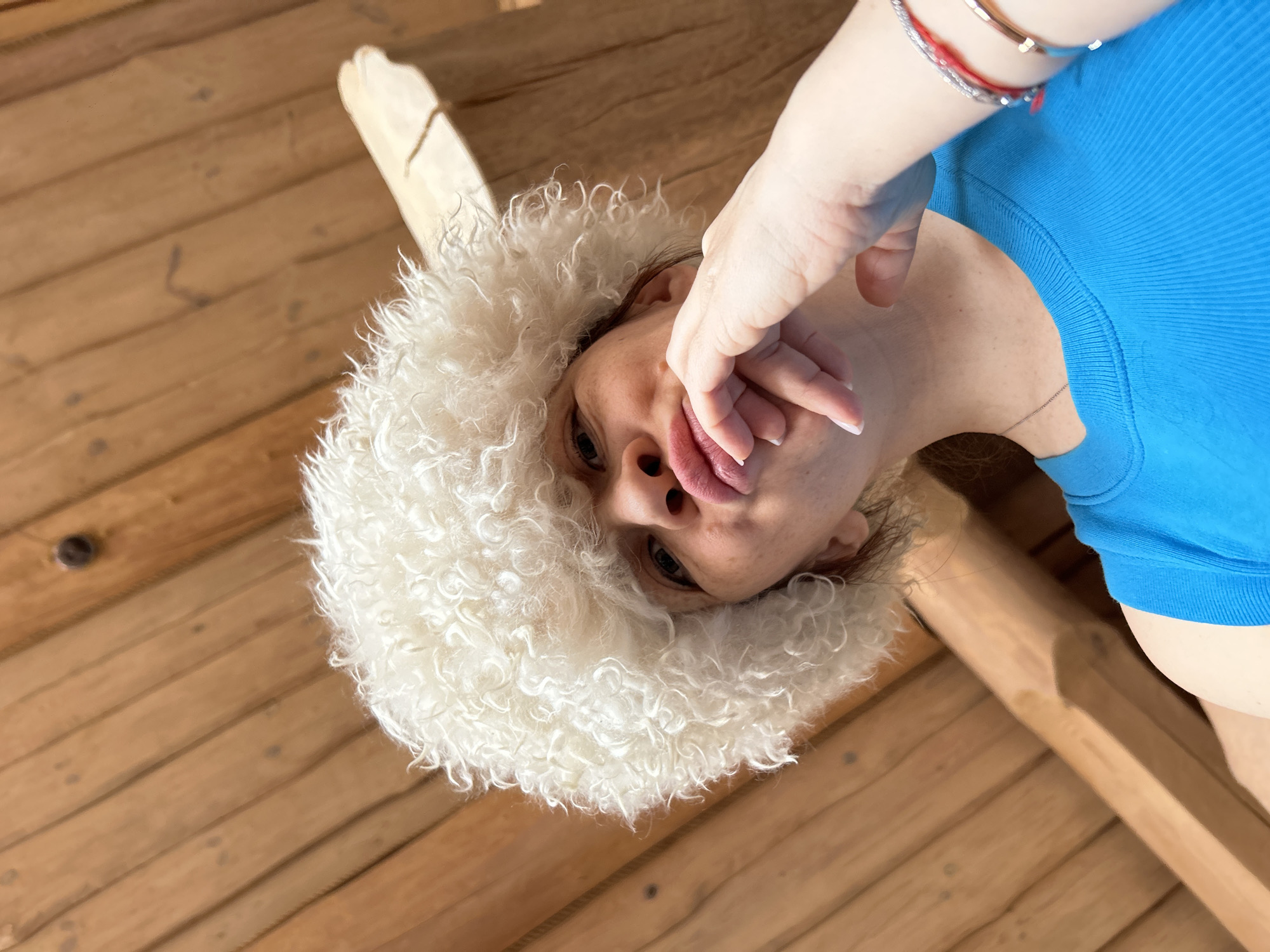 Woman in white fur hat photographed indoors in Novyi