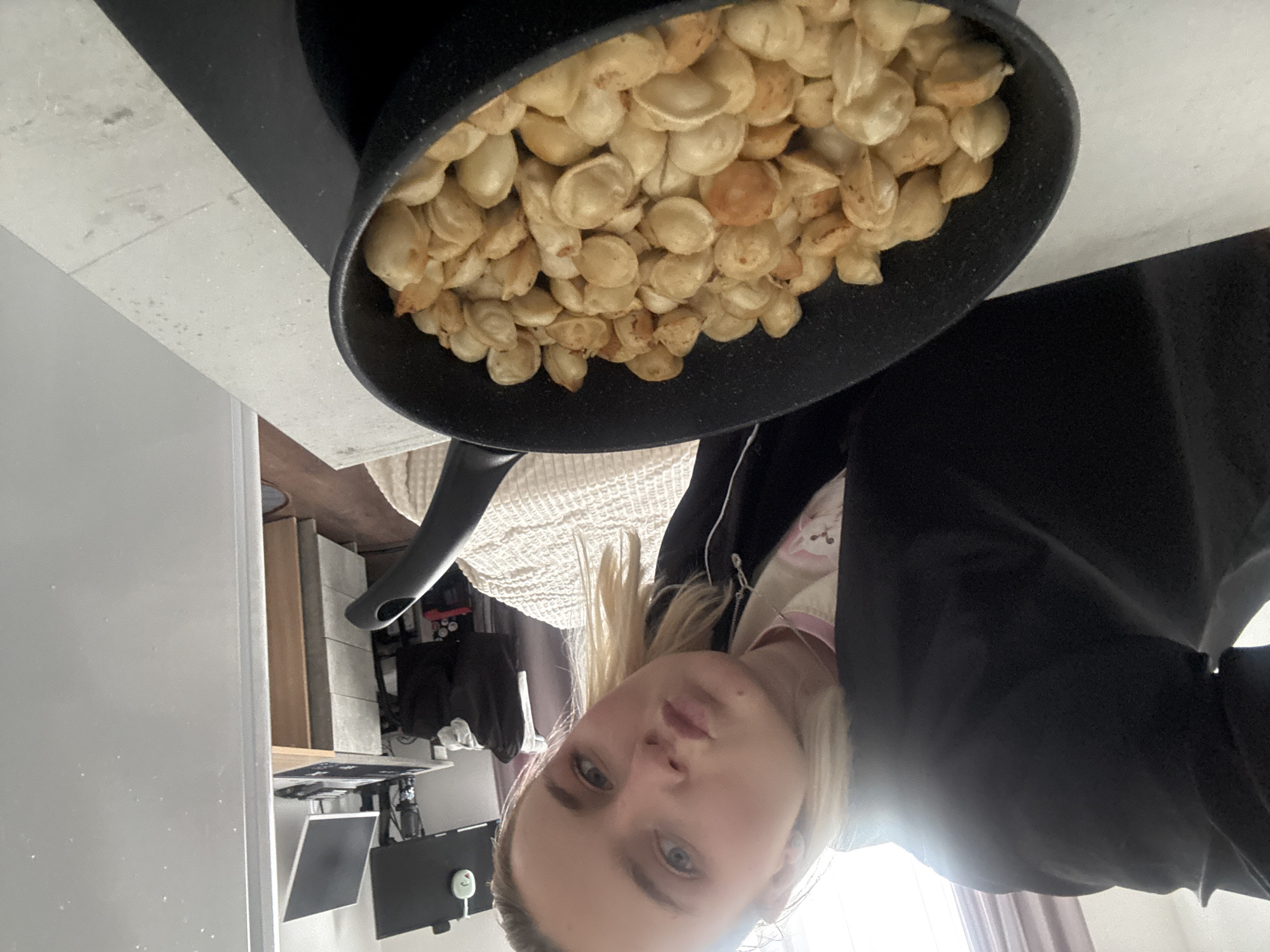 Woman documents cooking pelmeni and relaxing at home in Russia
