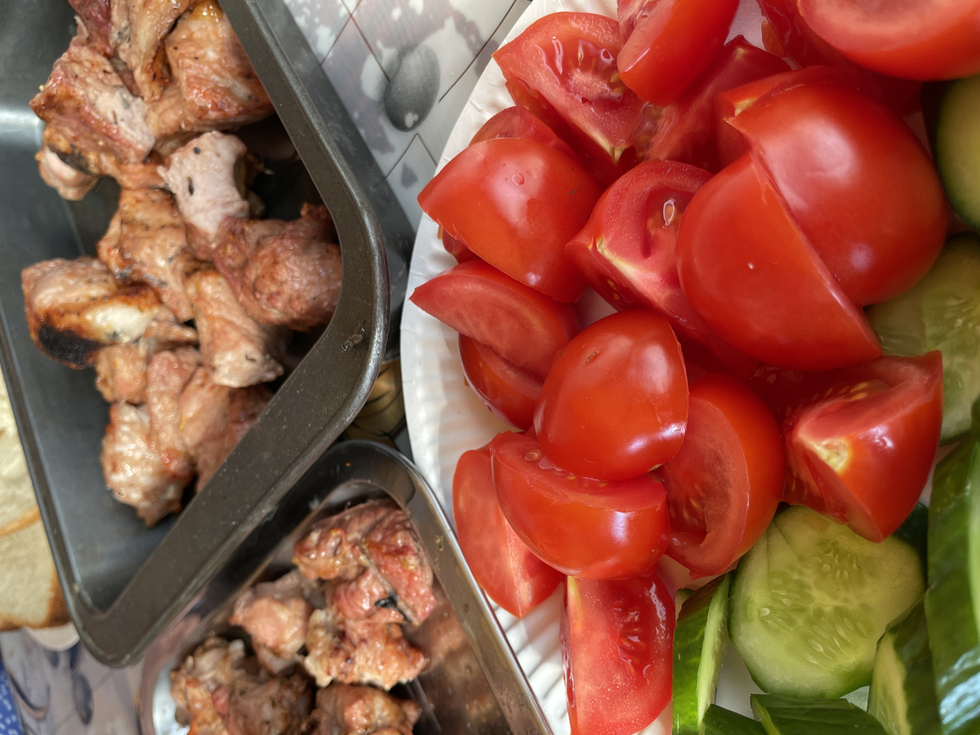 Outdoor shish kebab spread with beer and fresh vegetables, Novokuznetsk