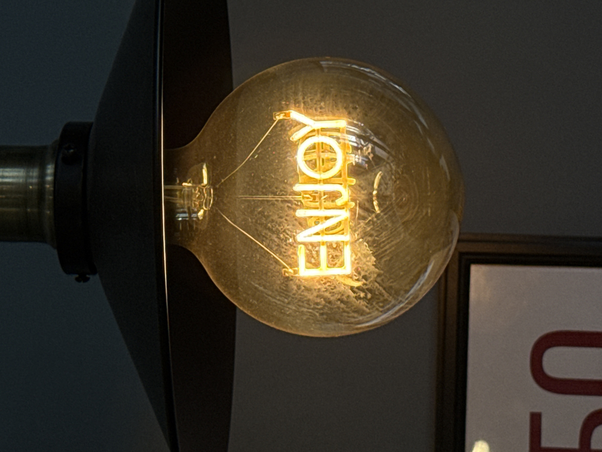 Decorative "ENJOY" light bulb photographed at Krasnoyarsk cafe