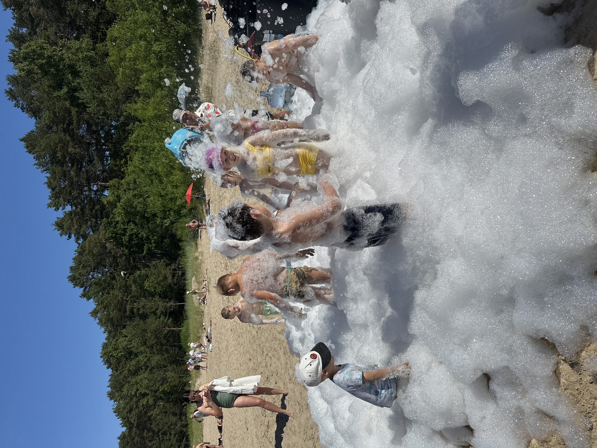 Foam party on Jūrmala's sandy beach on a sunny day