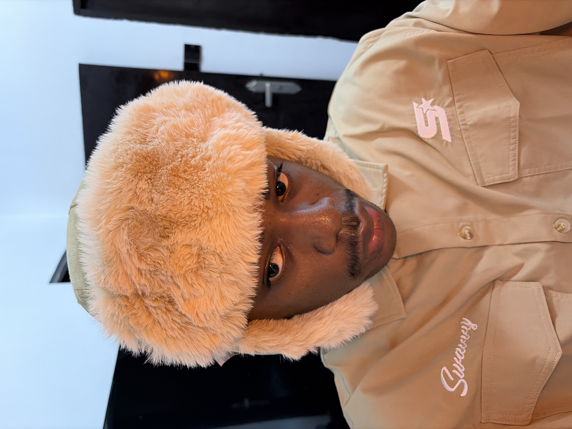 Young man takes selfies in tan Swarvy jacket in Nigeria