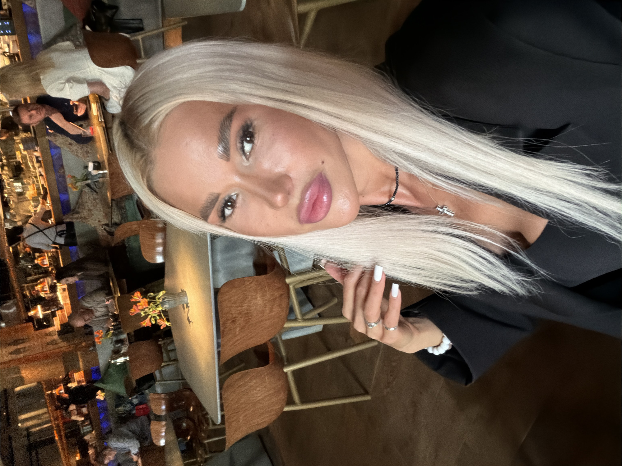Woman takes selfies at restaurant during late morning