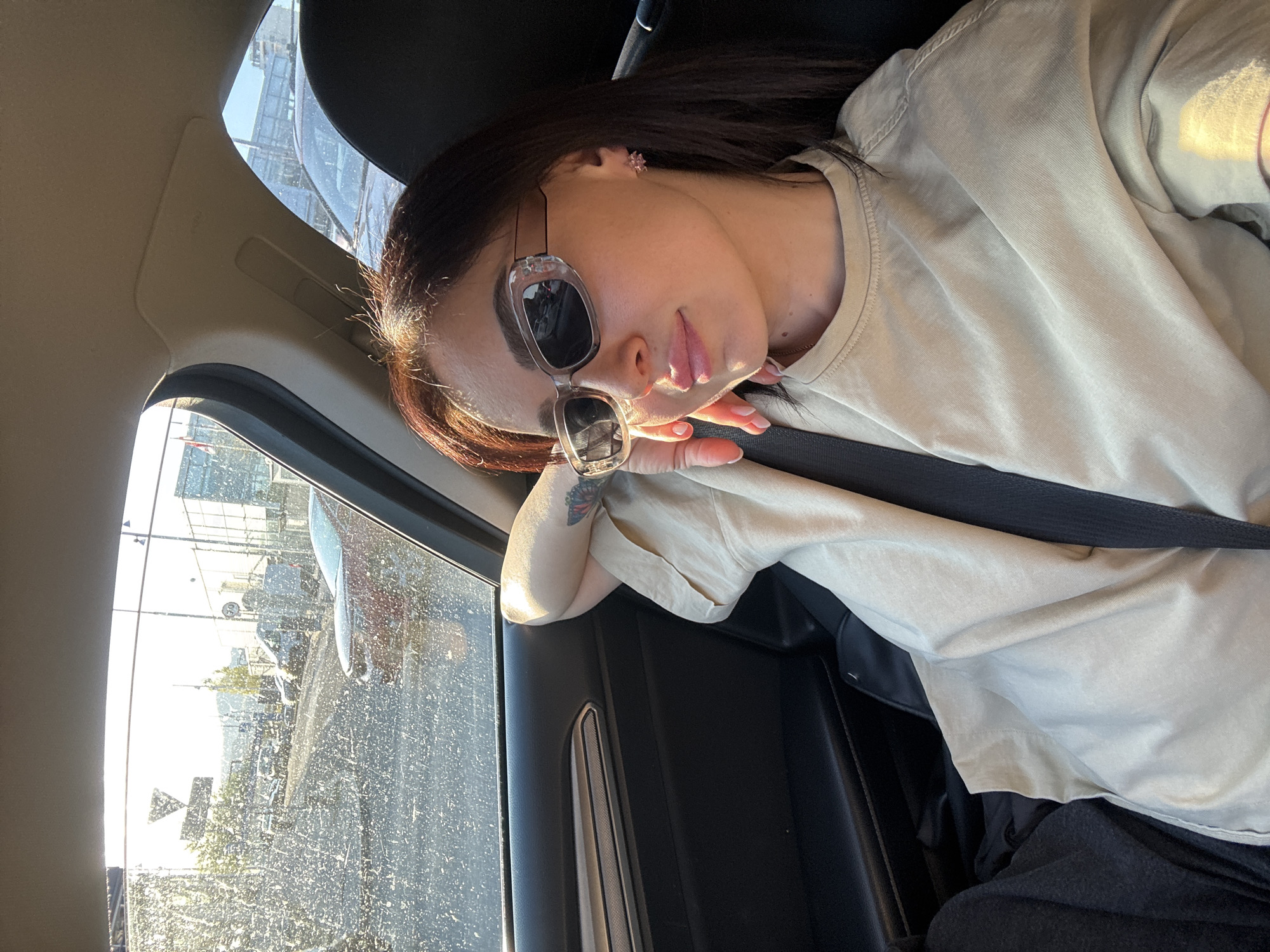 Woman photographed in multiple poses inside car in Tbilisi