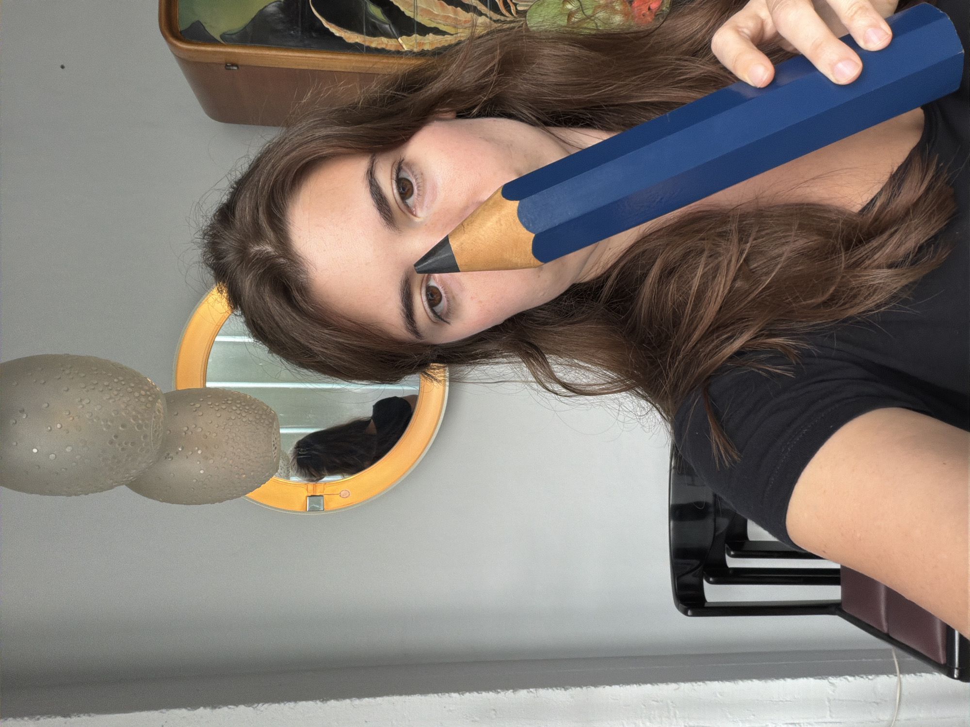 Person poses with oversized blue pencil in Buenos Aires