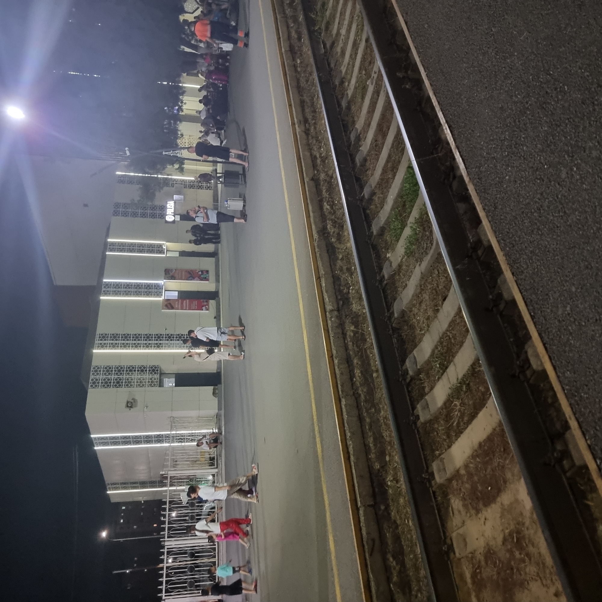 Night at Shymkent station: trains, crowds, and a Coca-Cola kiosk