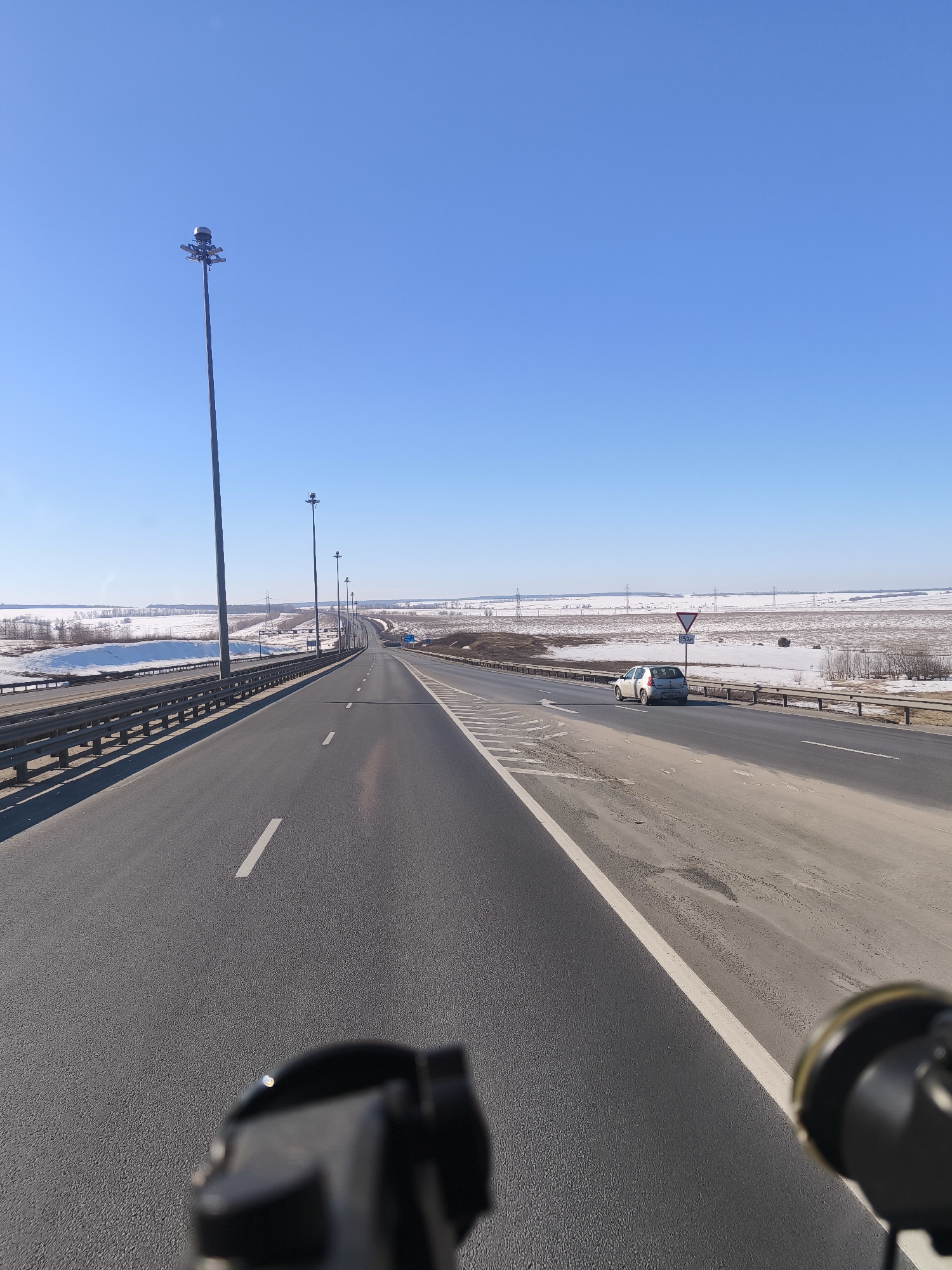 Highway bridge crosses snowy landscape in Shali, Russia