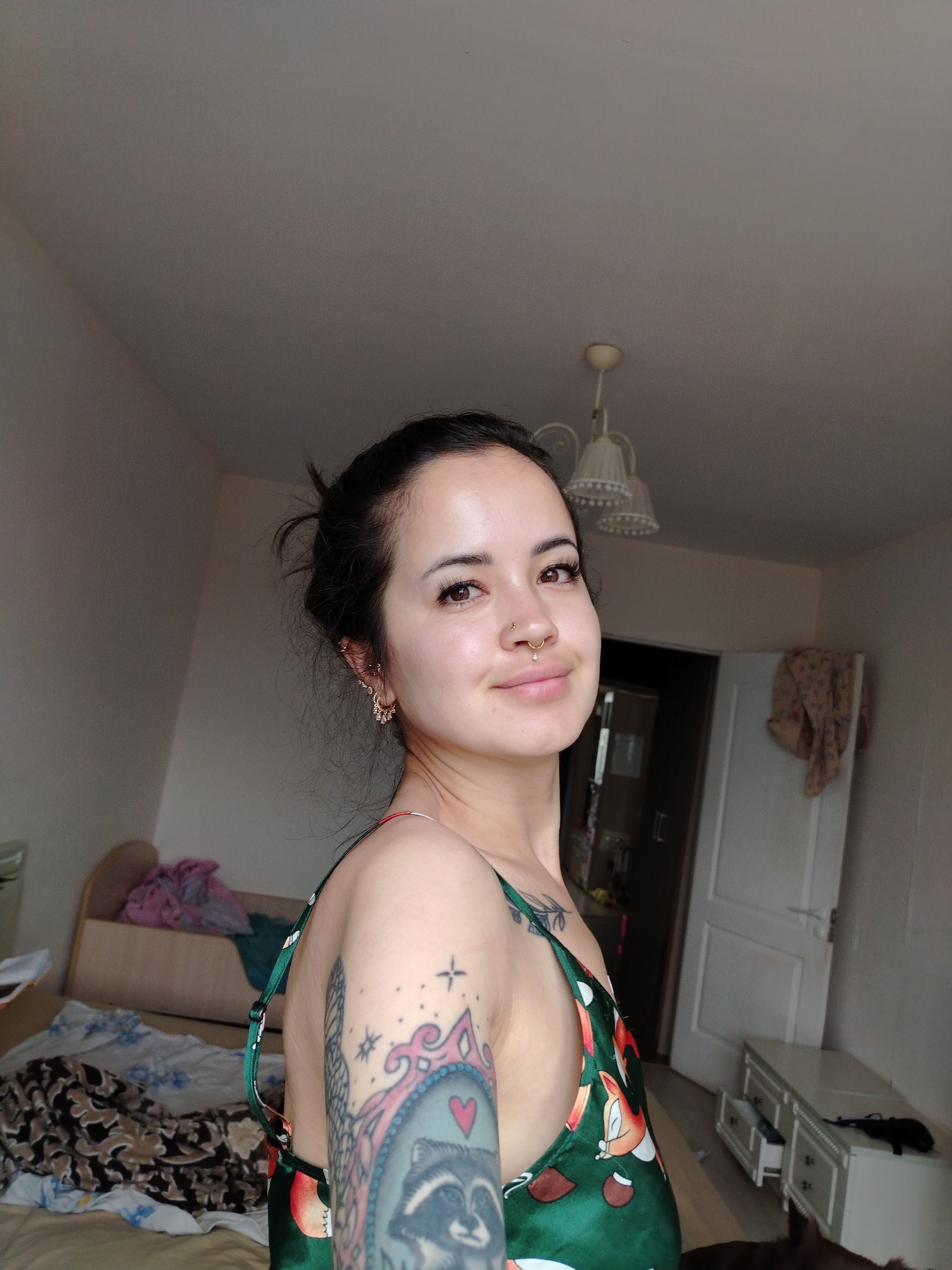 Tattooed woman in green dress documented in Noviy, Russia
