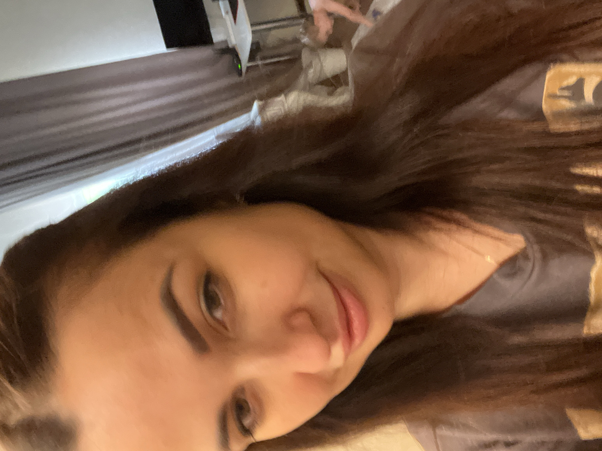 Woman takes multiple selfies during indoor photo session