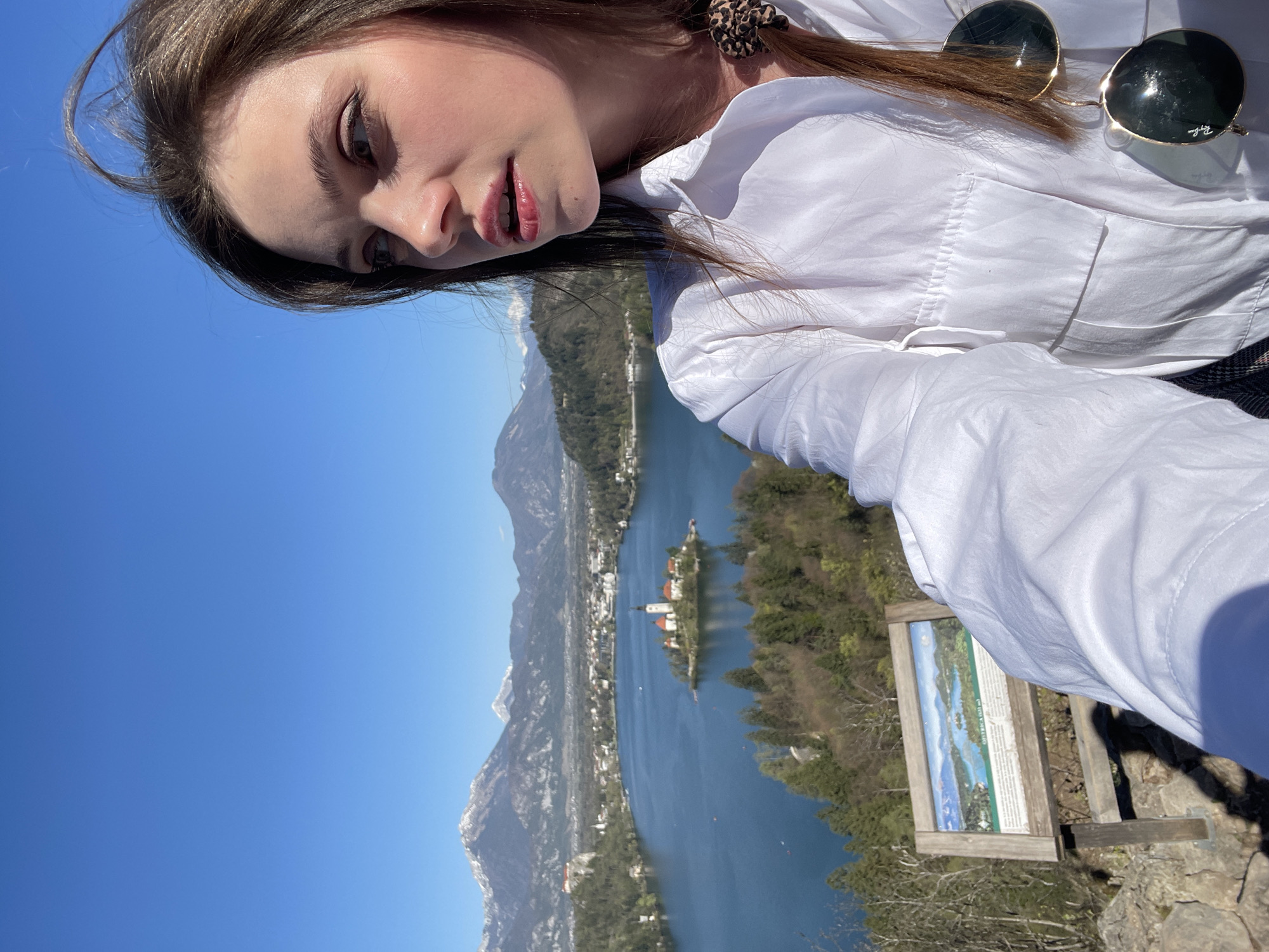Tourist photographed at Lake Bled's scenic wooden dock