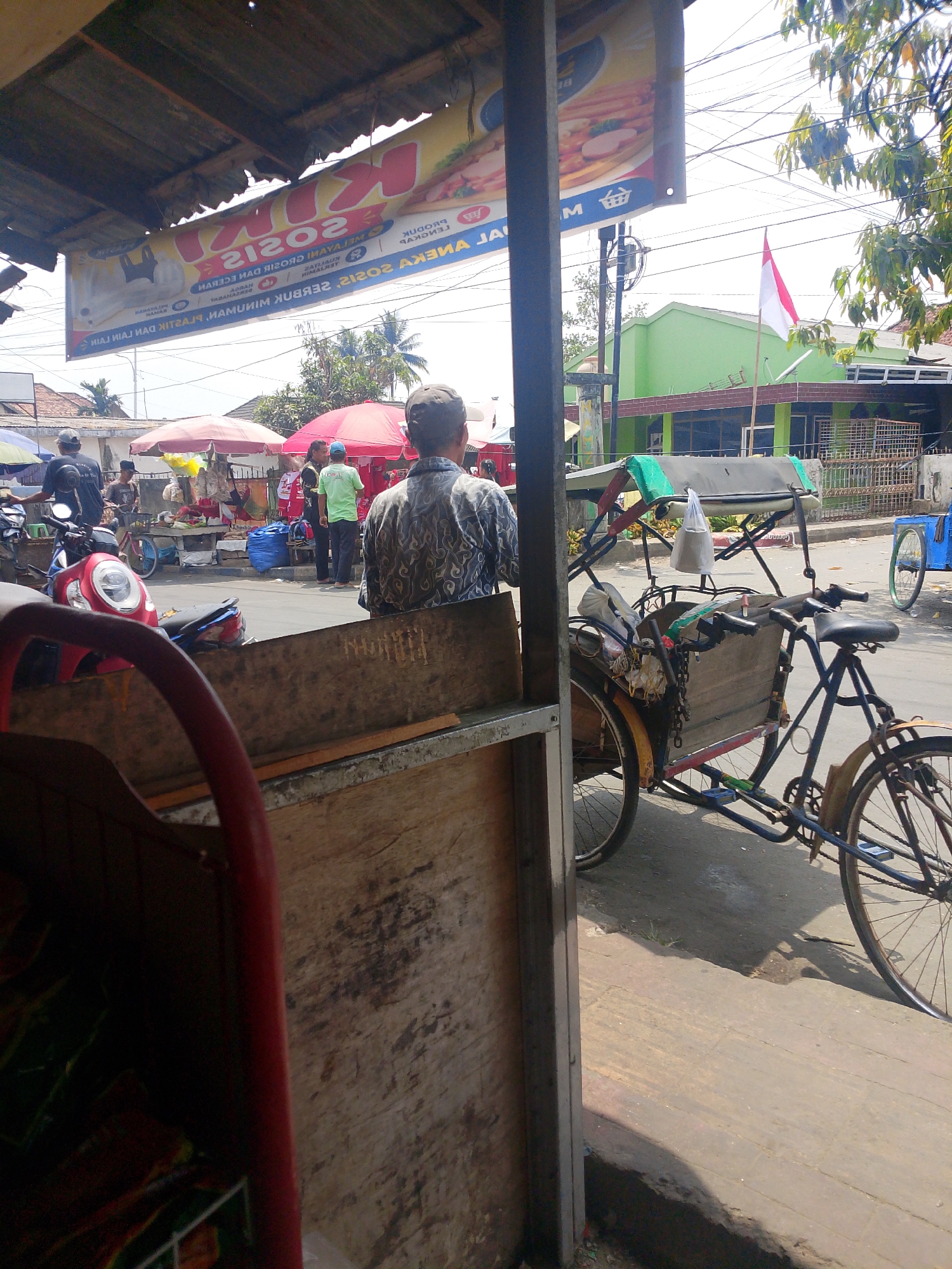 Street stalls and local food signage along a Palembang commercial strip