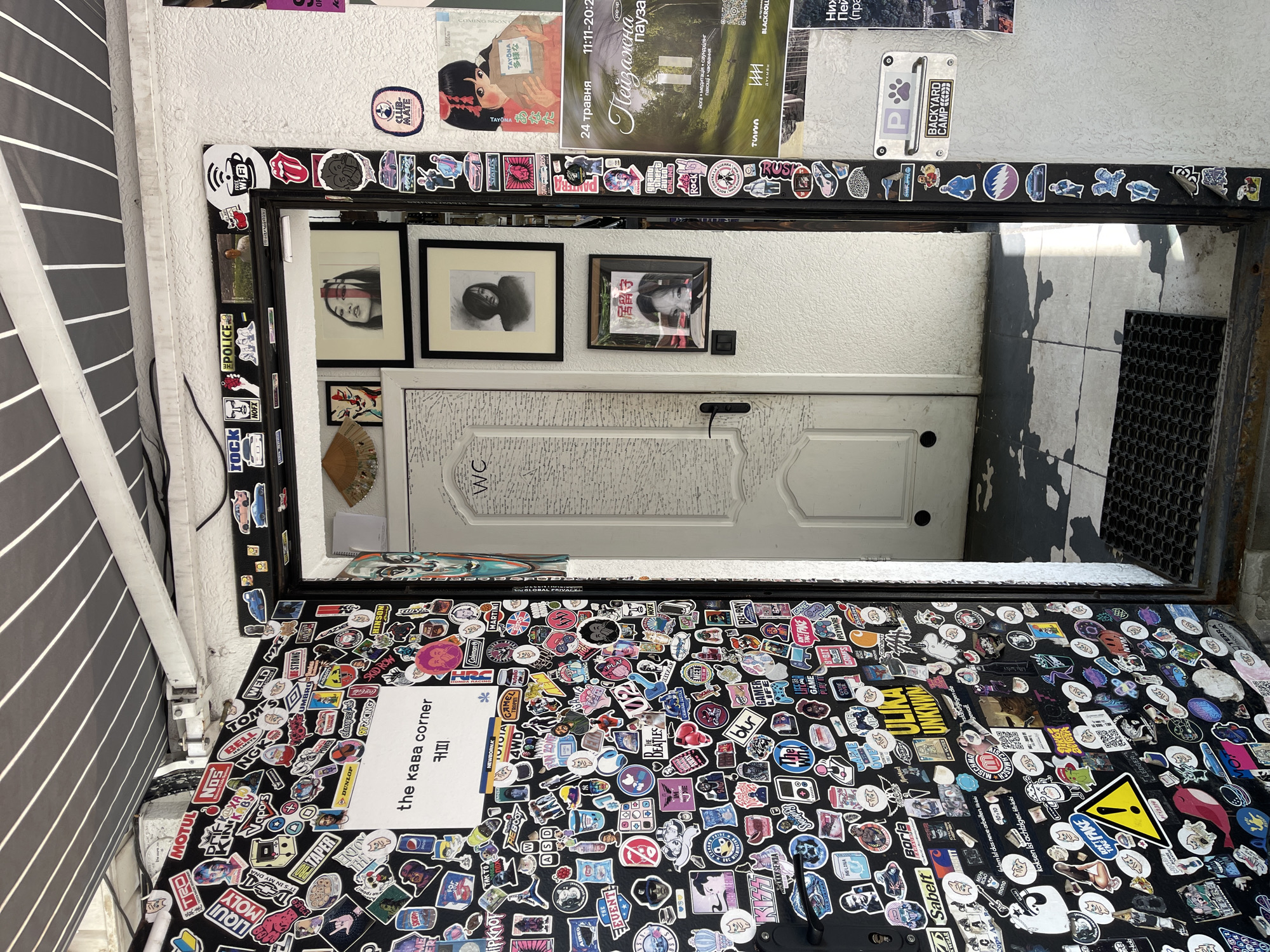 Artistic indoor space with decorated walls and mirrors documented
