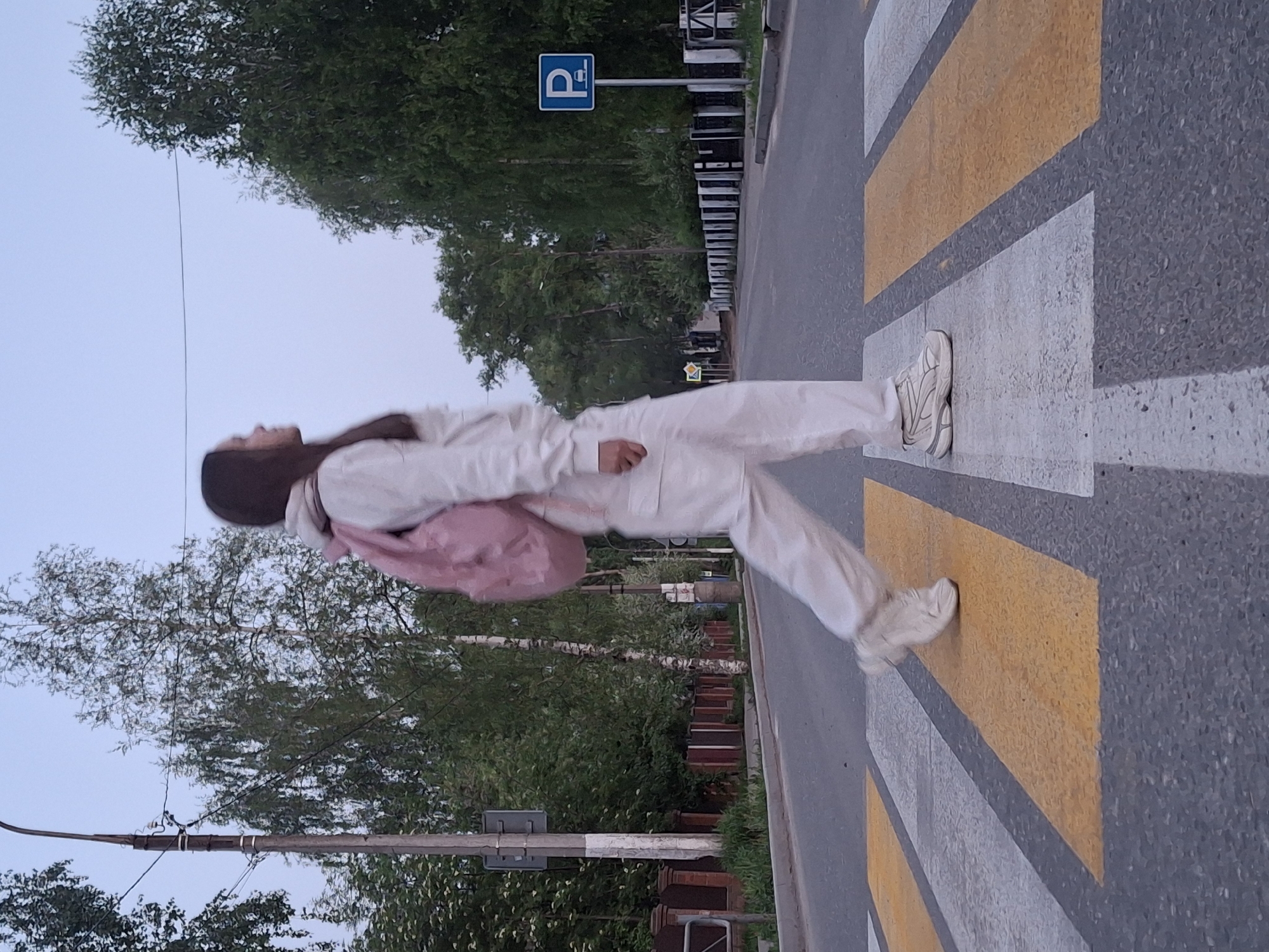 Evening pedestrian crossing and lilac blooms captured in Chaikovsky