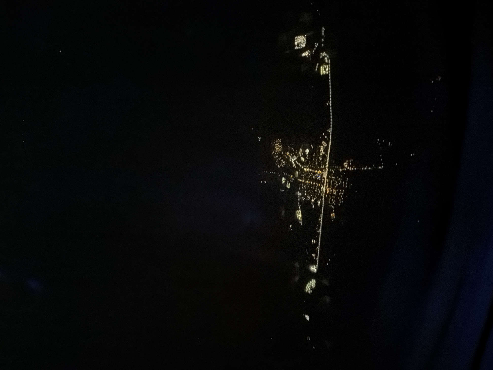 Aerial nighttime view of Lordsburg captured from airplane window