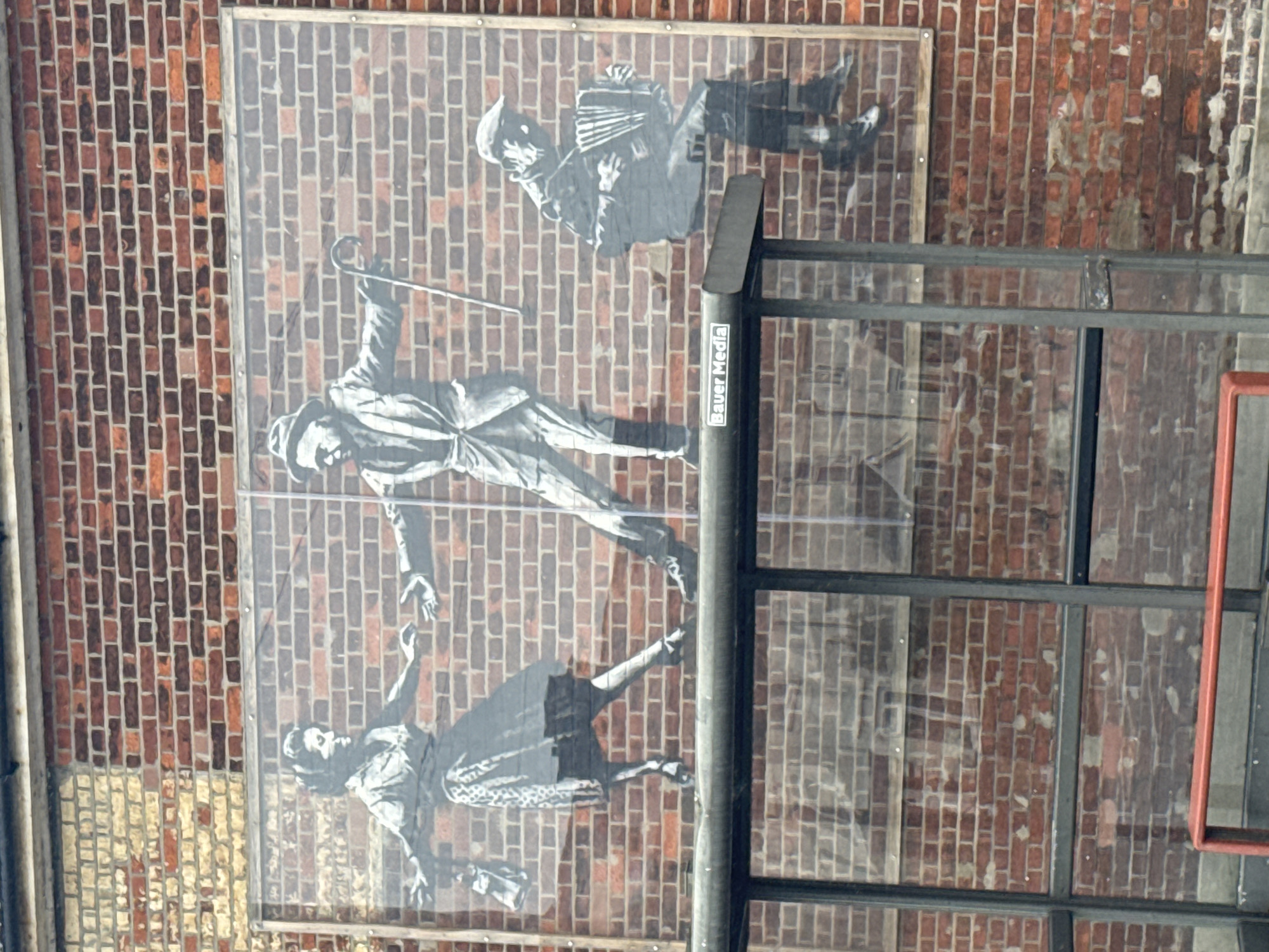 Street mural shows dancing figures, accordion player in Great Yarmouth