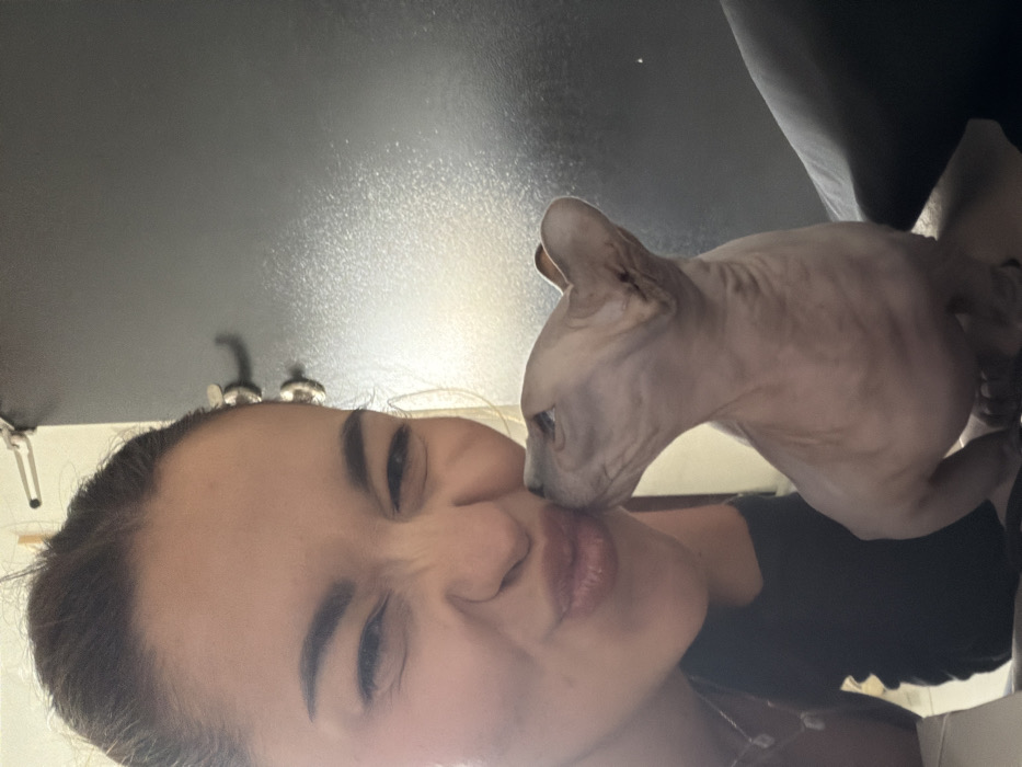 Woman documents morning routine with Sphynx cat in Tel Aviv