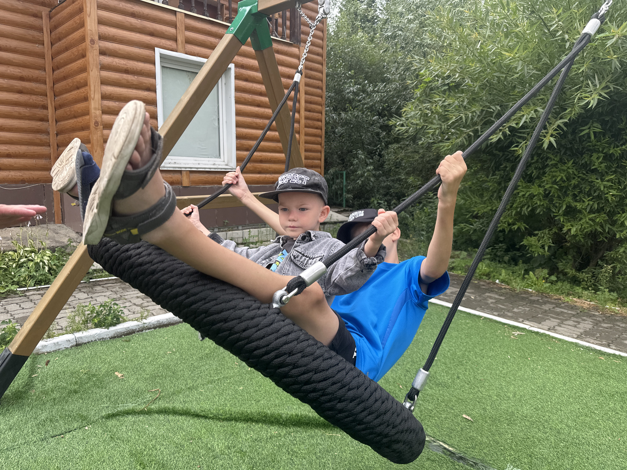 Kids playing hard on a backyard playground in rural Altai