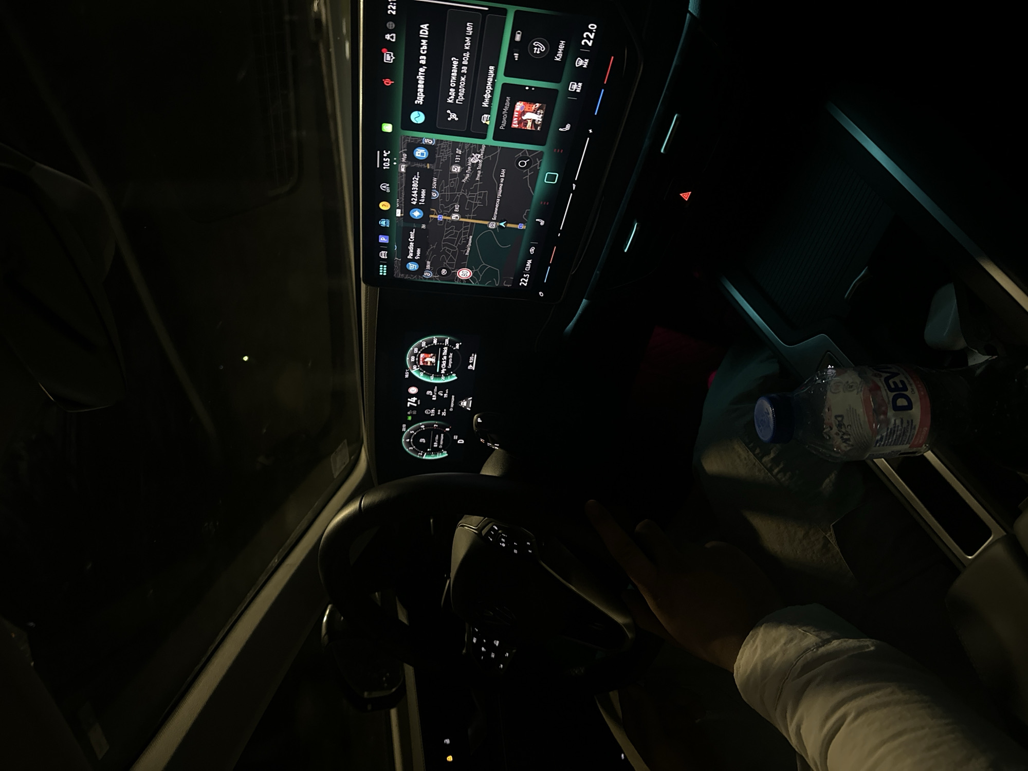 Driver navigates Sofia streets at night with dashboard display