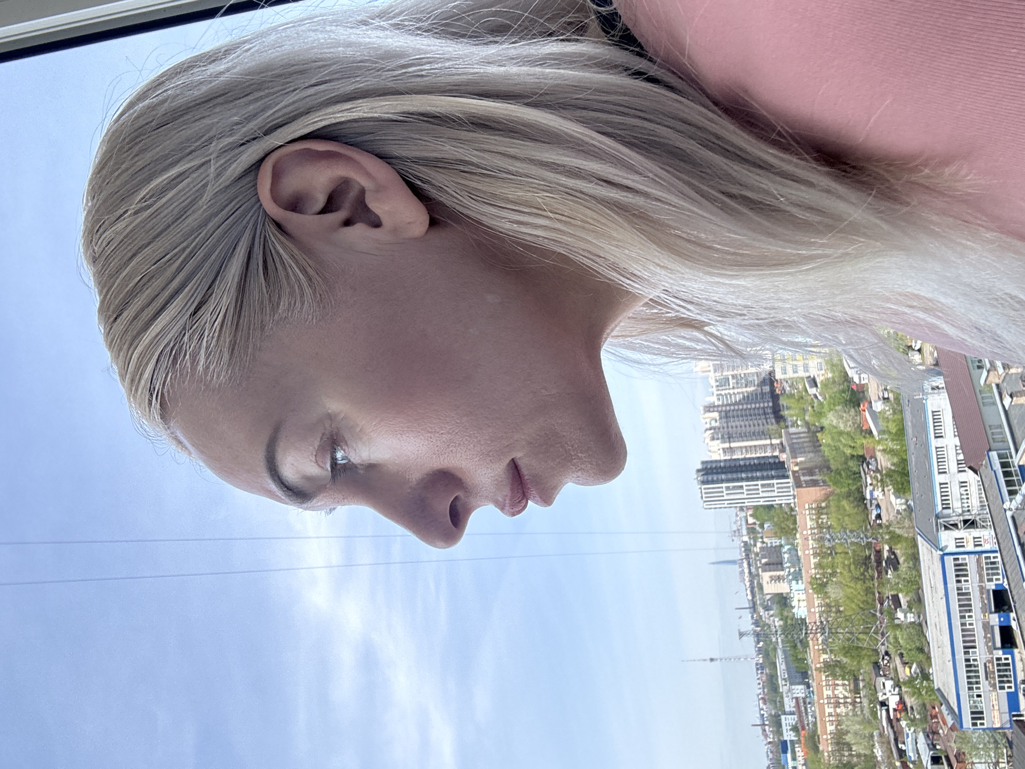 Woman documents Russian cityscape from elevated viewpoint