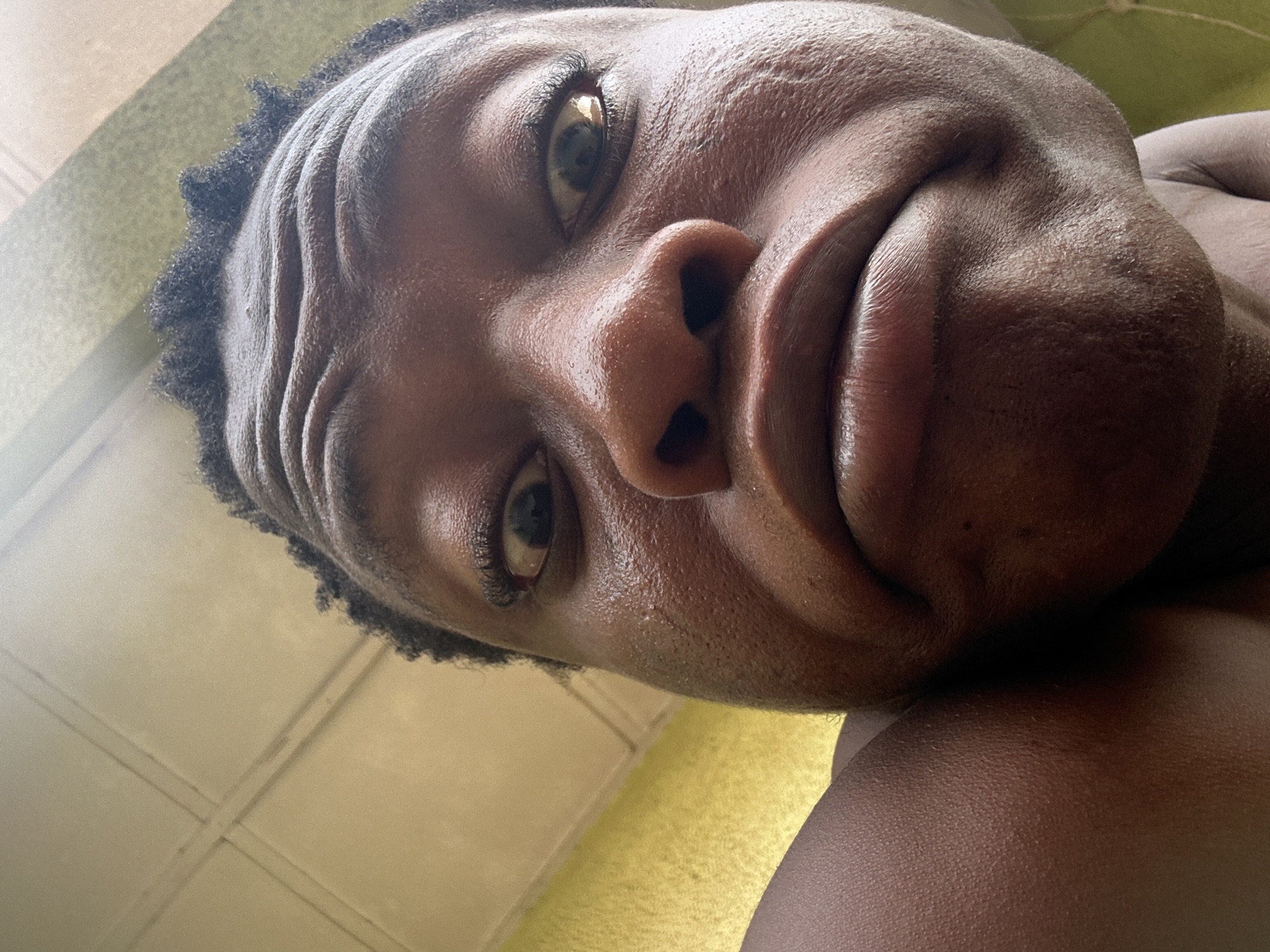 Individual observed with tilted head, contorted expression