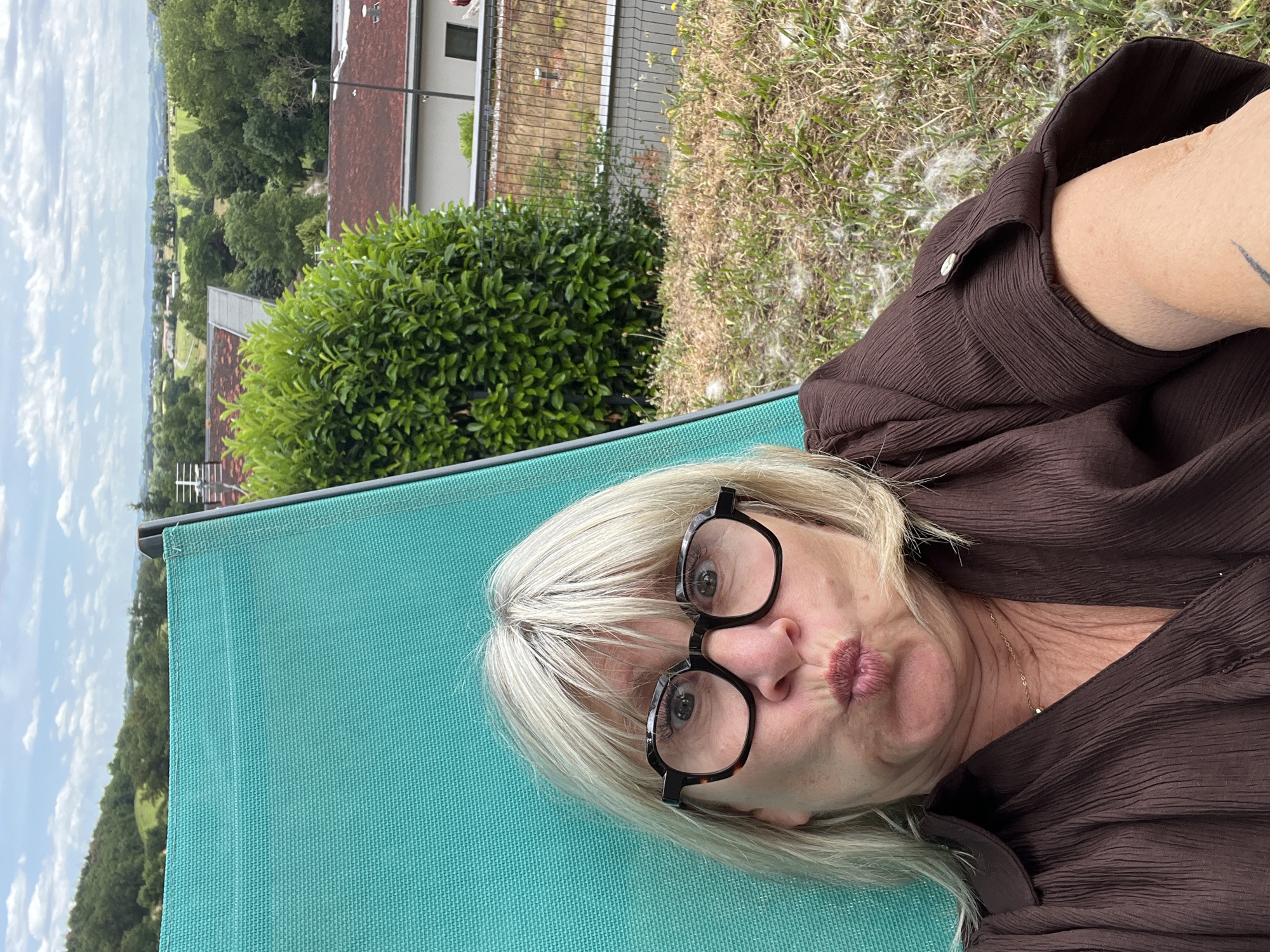 Woman enjoys afternoon reading session in French garden