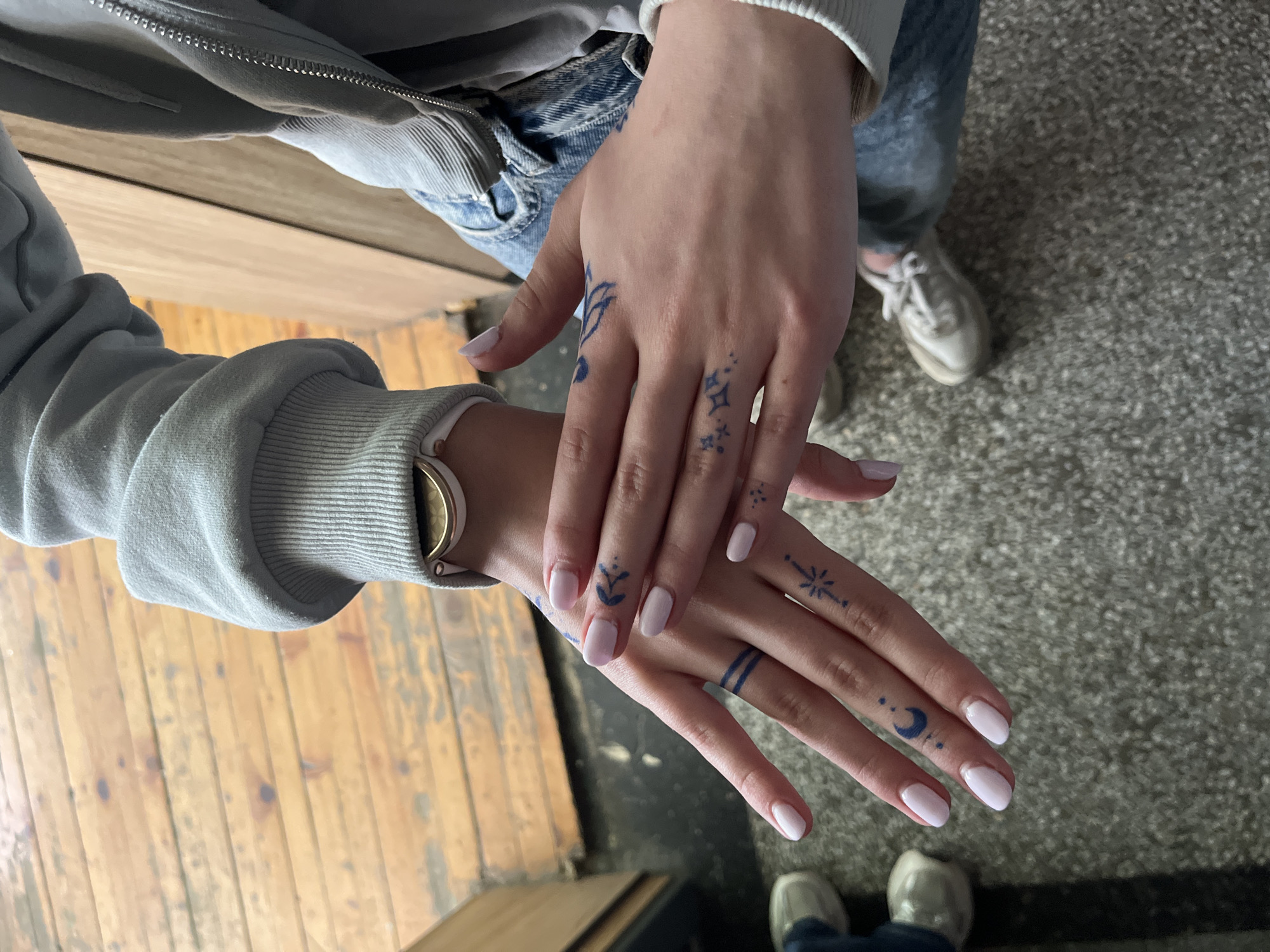 Person documents blue tattoos and pink nails in Ruse
